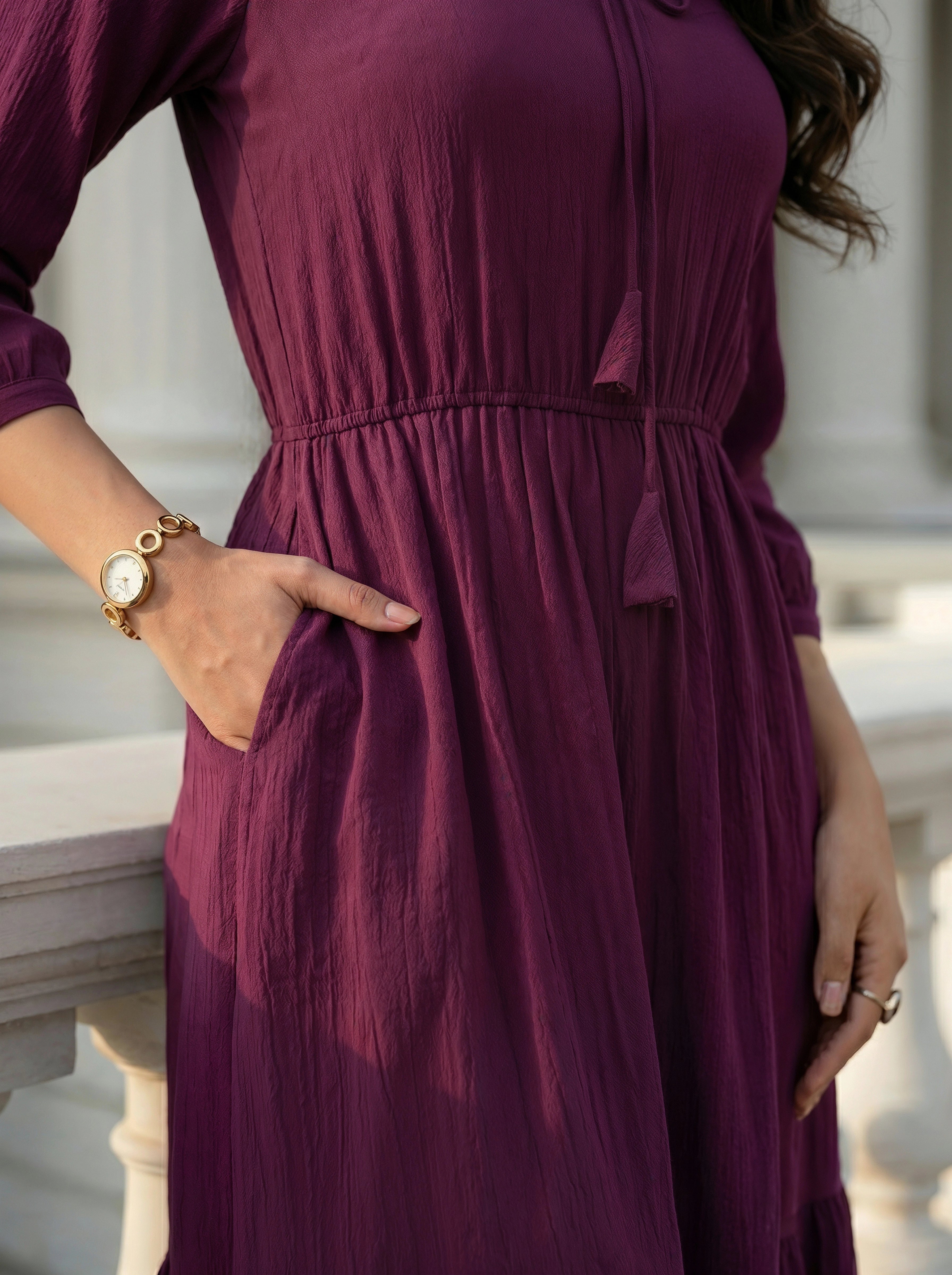 Person wearing a purple dress with a blurred background