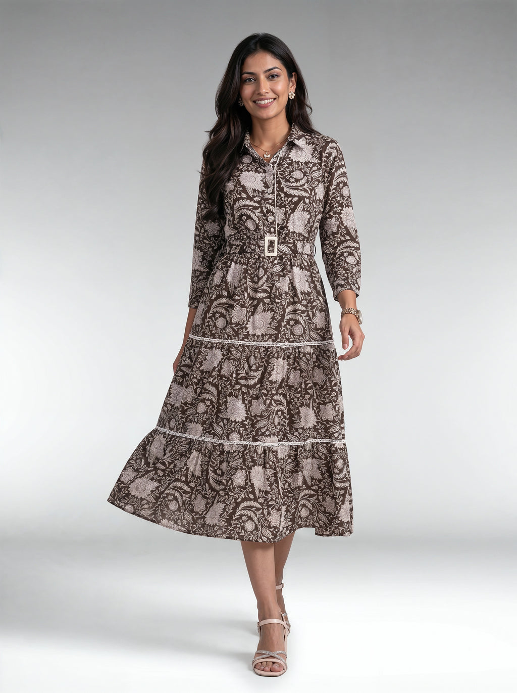 A woman wearing a white tiered midi dress with textured knit sleeves and a high neck, shown from the back against a solid light purple studio background.