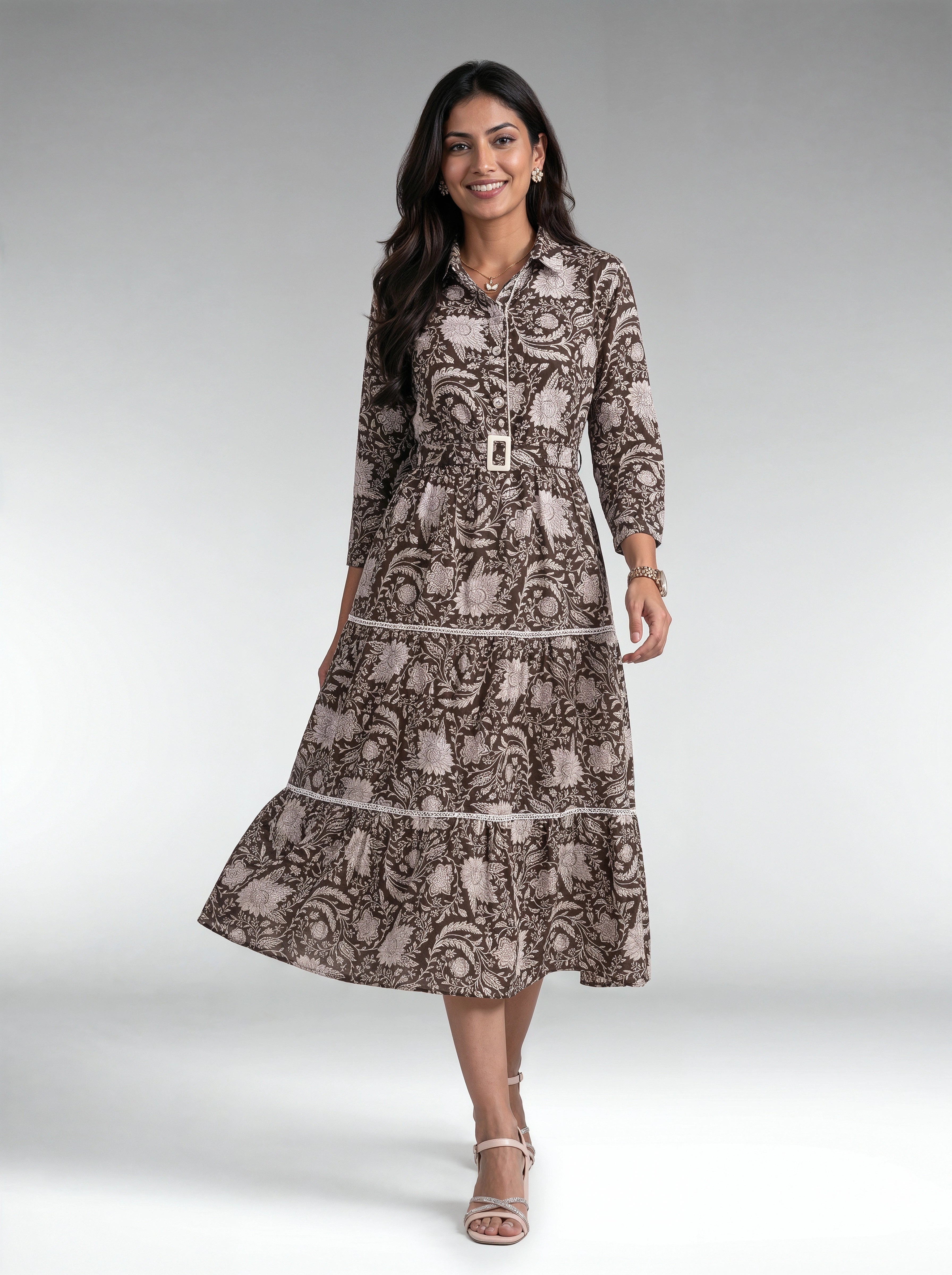 A woman wearing a white tiered midi dress with textured knit sleeves and a high neck, shown from the back against a solid light purple studio background.
