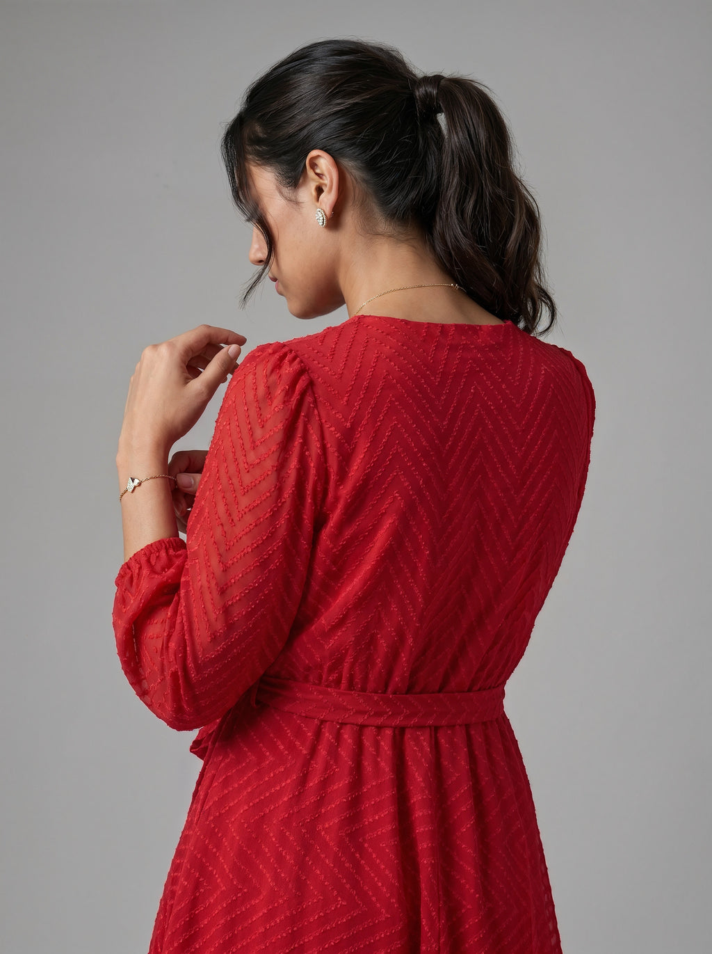 Woman wearing a red dress against a gray background