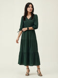 Woman wearing a green dress against a white background