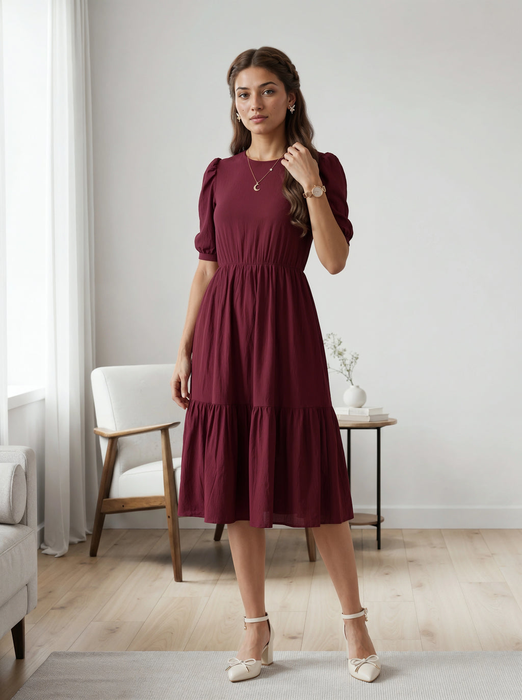 Woman wearing a burgundy dress in a room with light-colored walls and furniture.
