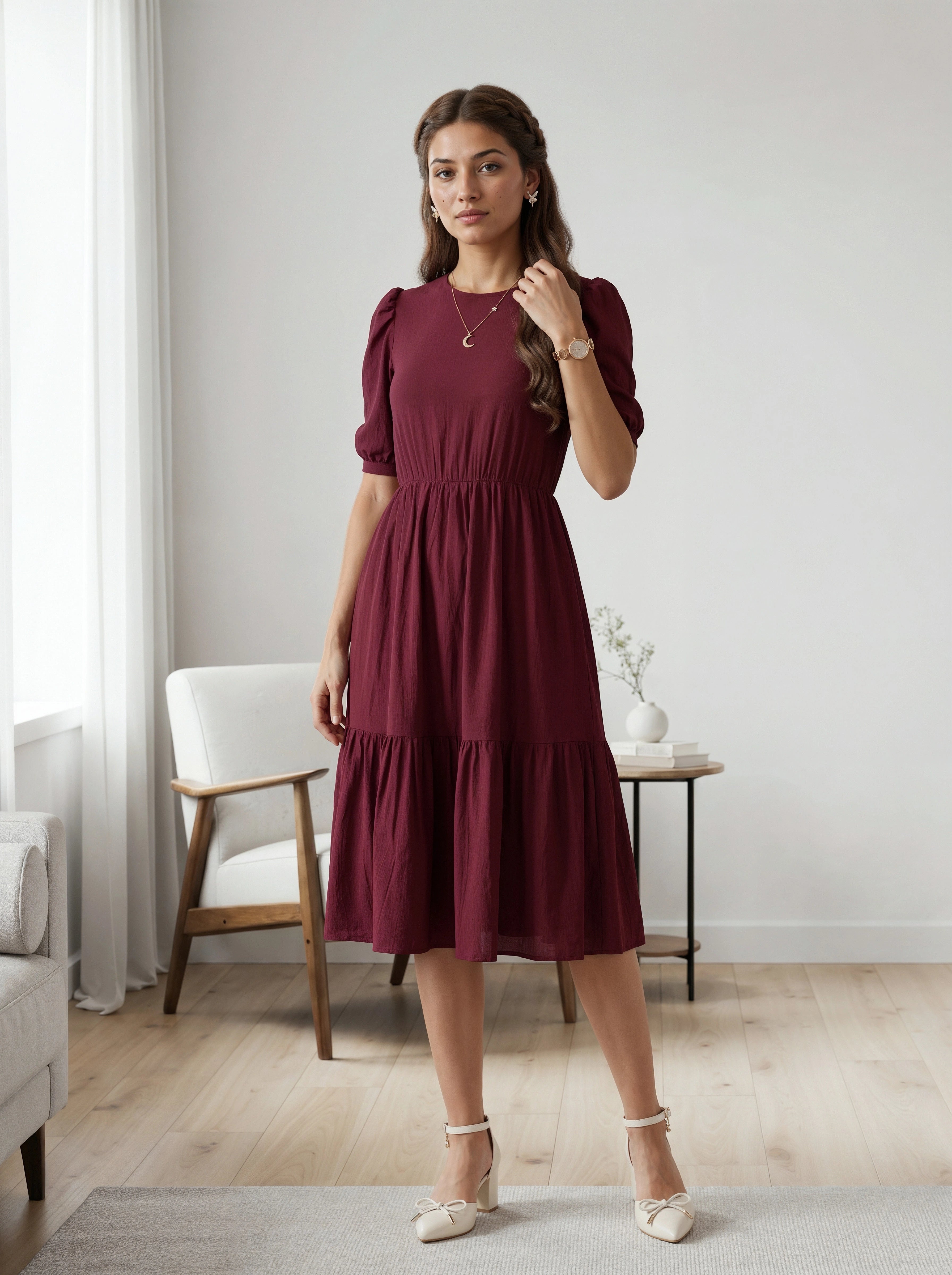 Woman wearing a burgundy dress in a room with light-colored walls and furniture.