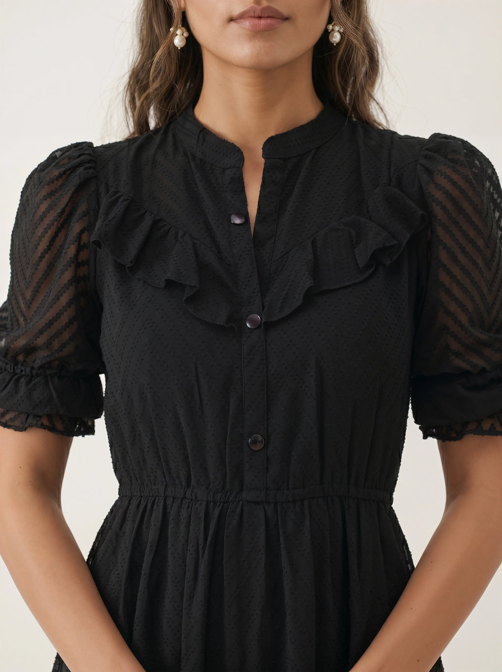Woman wearing a black dress against a white background