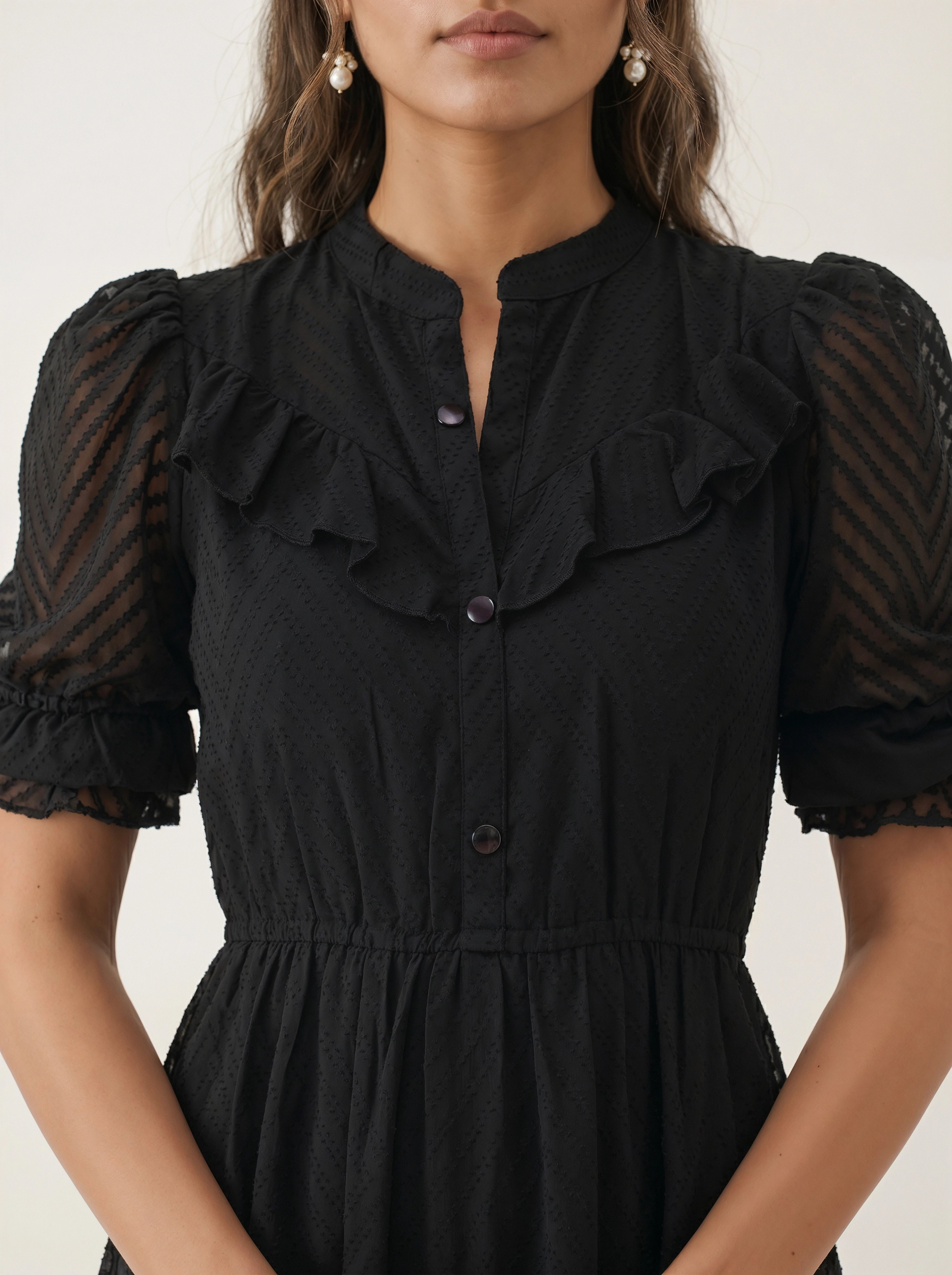 Woman wearing a black dress against a white background