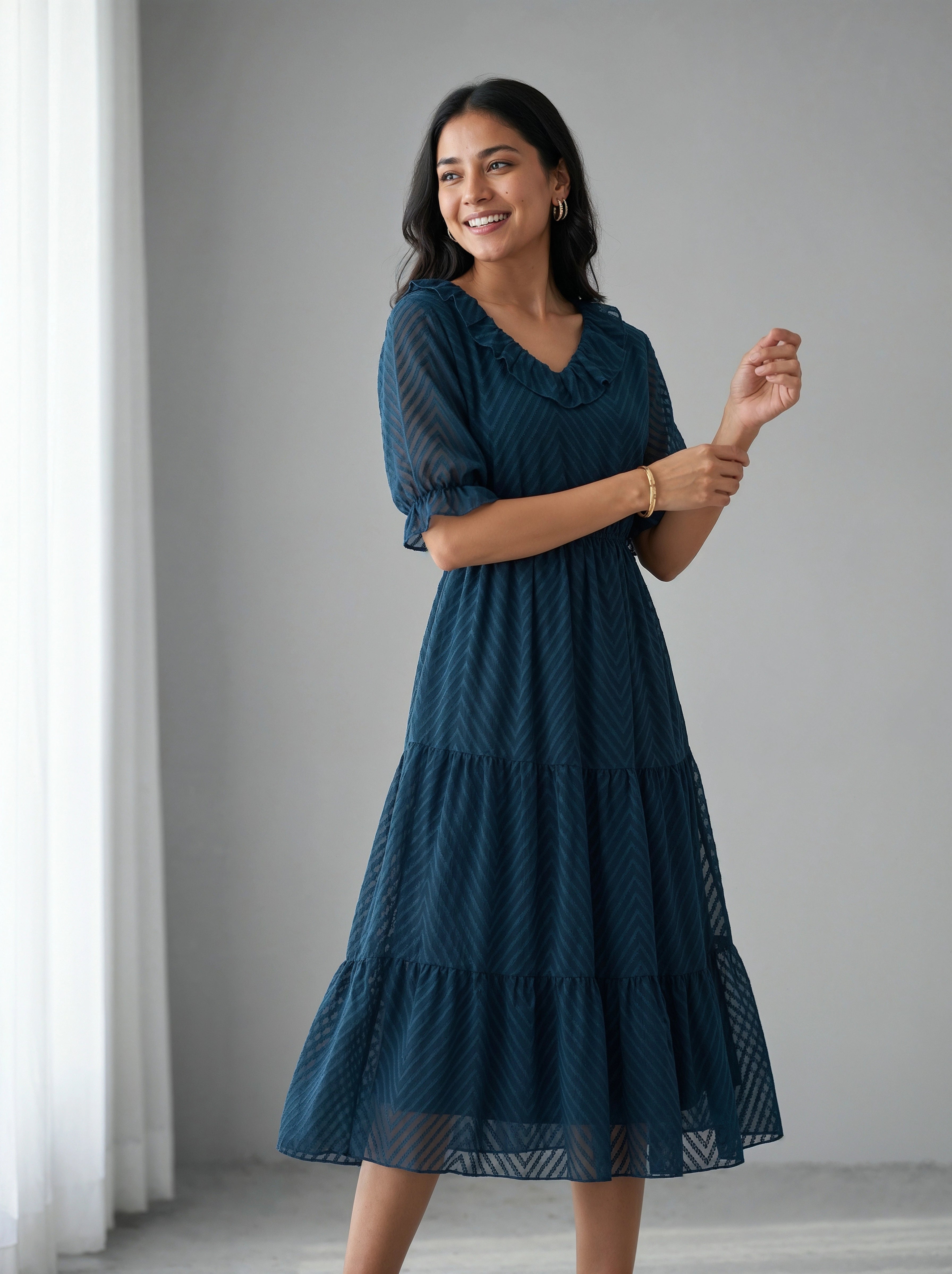 Woman wearing a blue dress against a gray background