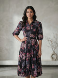 Woman wearing a floral dress against a neutral background