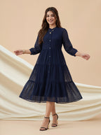 Woman wearing a navy blue dress with a beige background