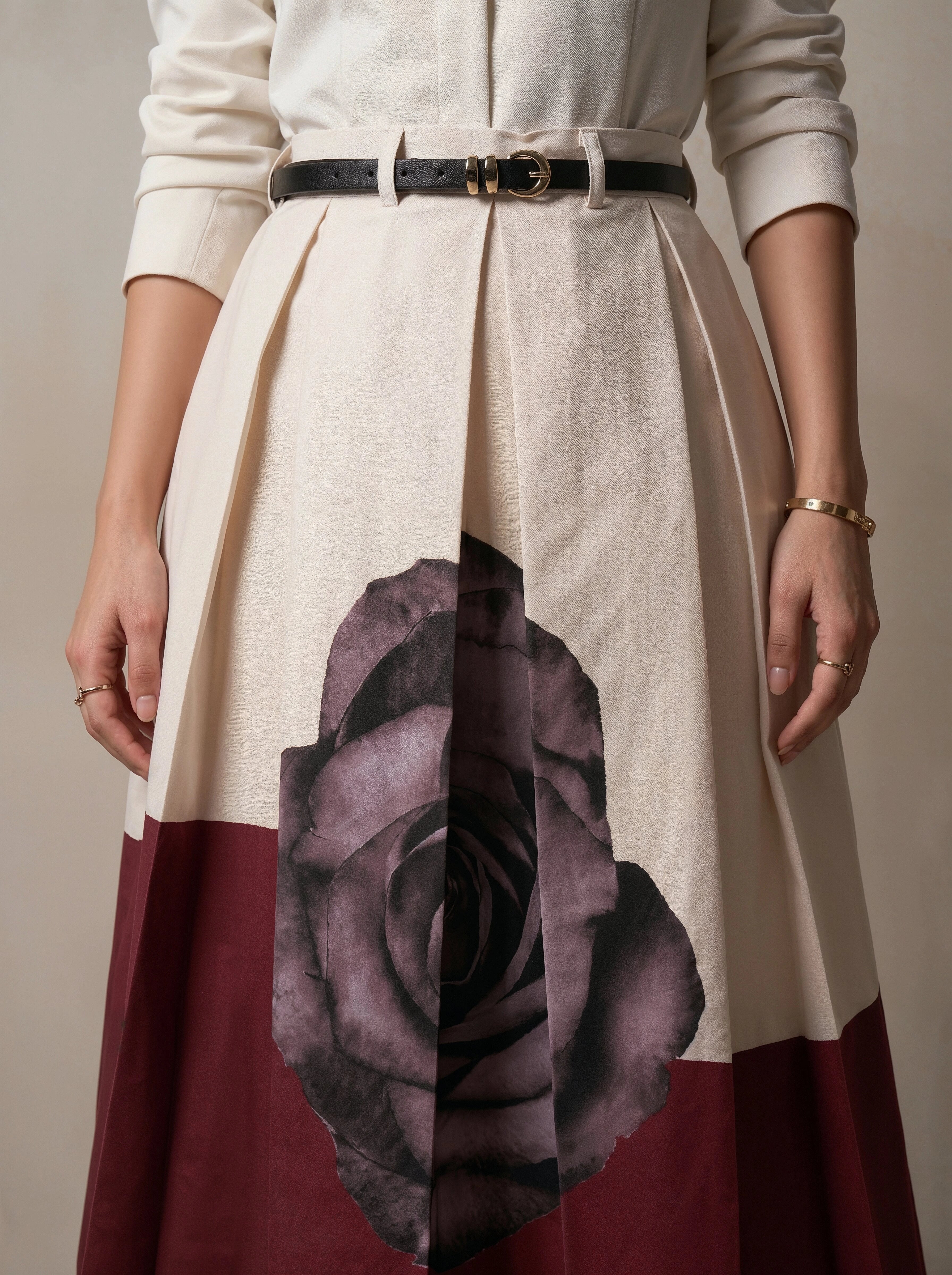 Skirt with floral design and color block pattern worn by a person against a neutral background
