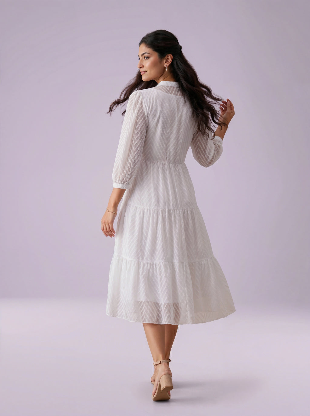 Woman wearing a white dress on a light purple background