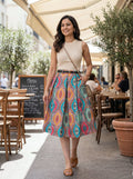 Woman in a colorful skirt walking outdoors in a cafe setting