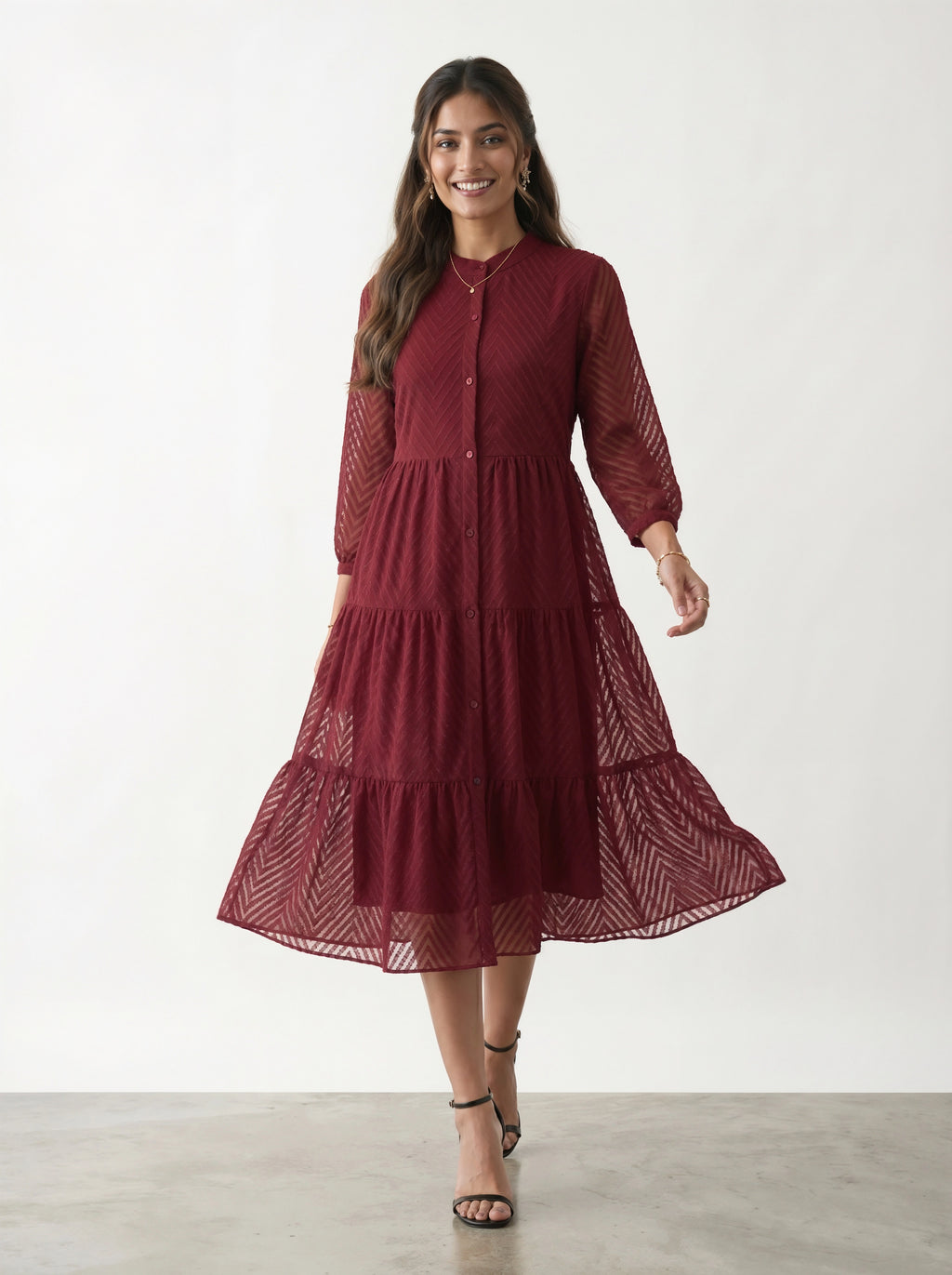 Woman wearing a burgundy dress with a white background