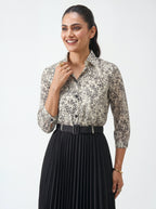 Woman wearing a floral blouse and black pleated skirt on a white background