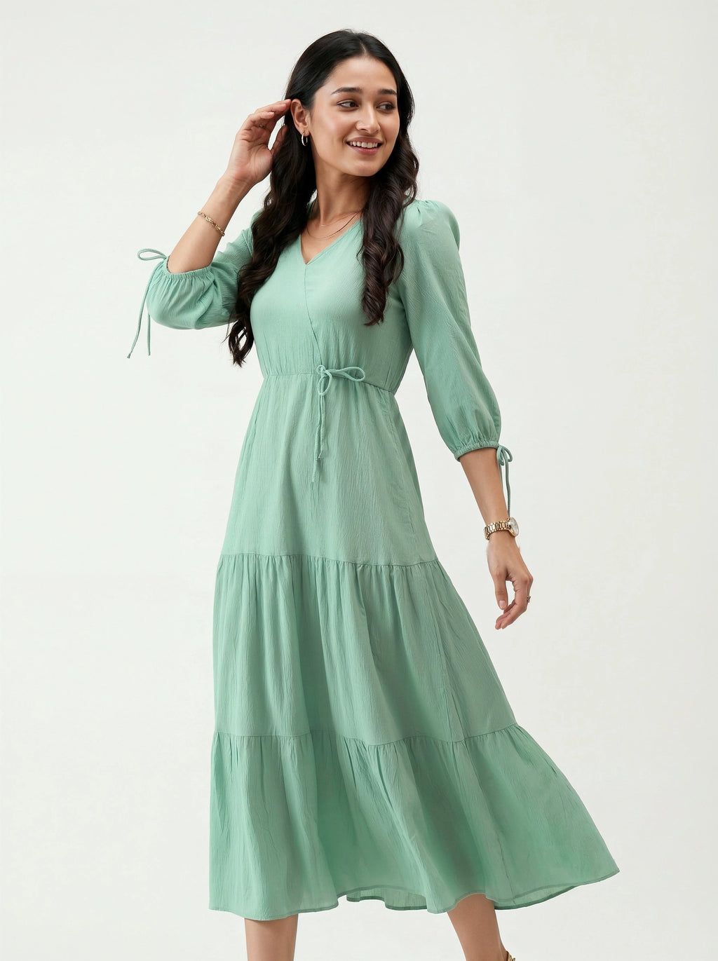 Woman wearing a light green dress on a white background