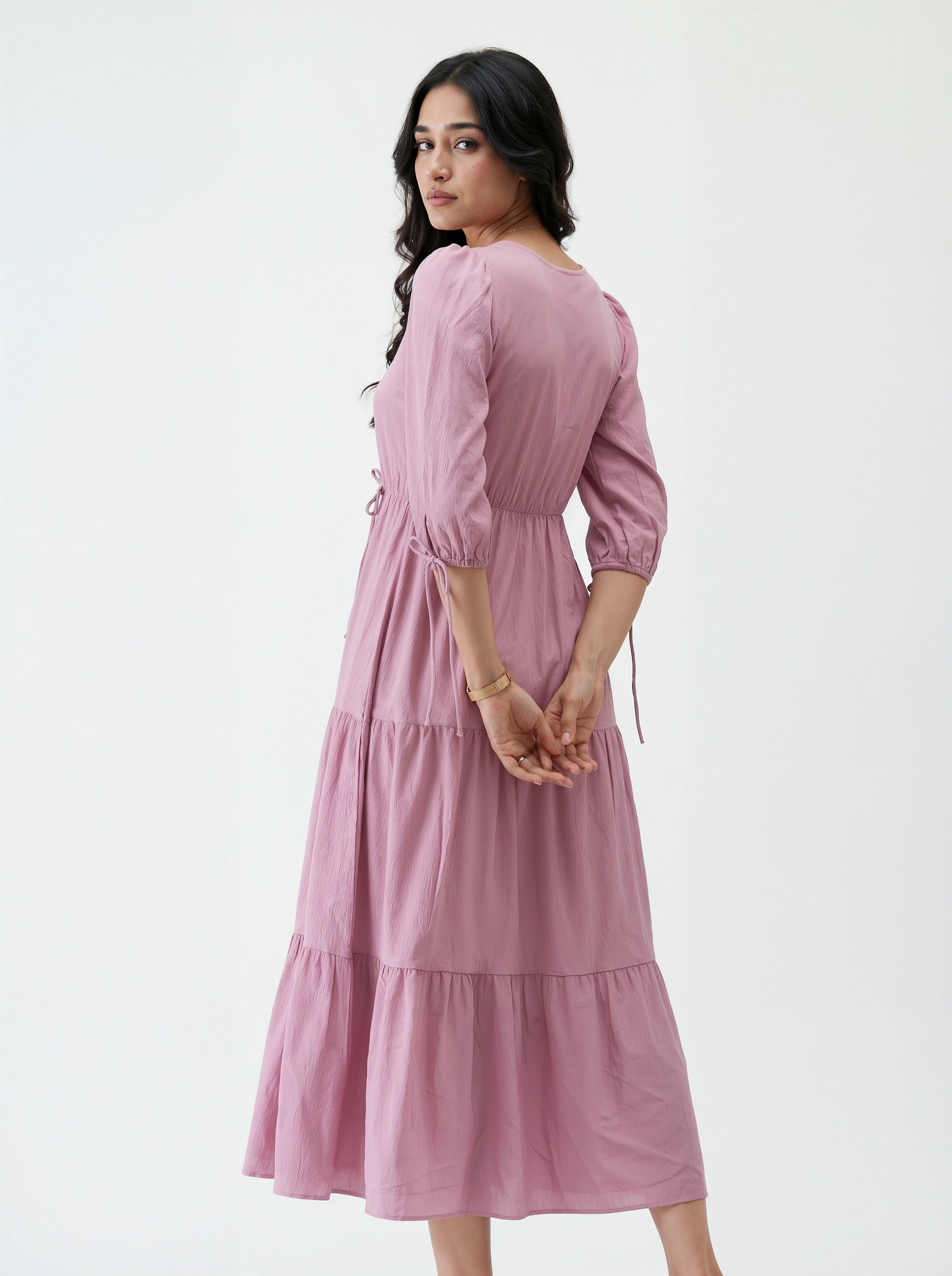 Woman wearing a pink dress on a white background