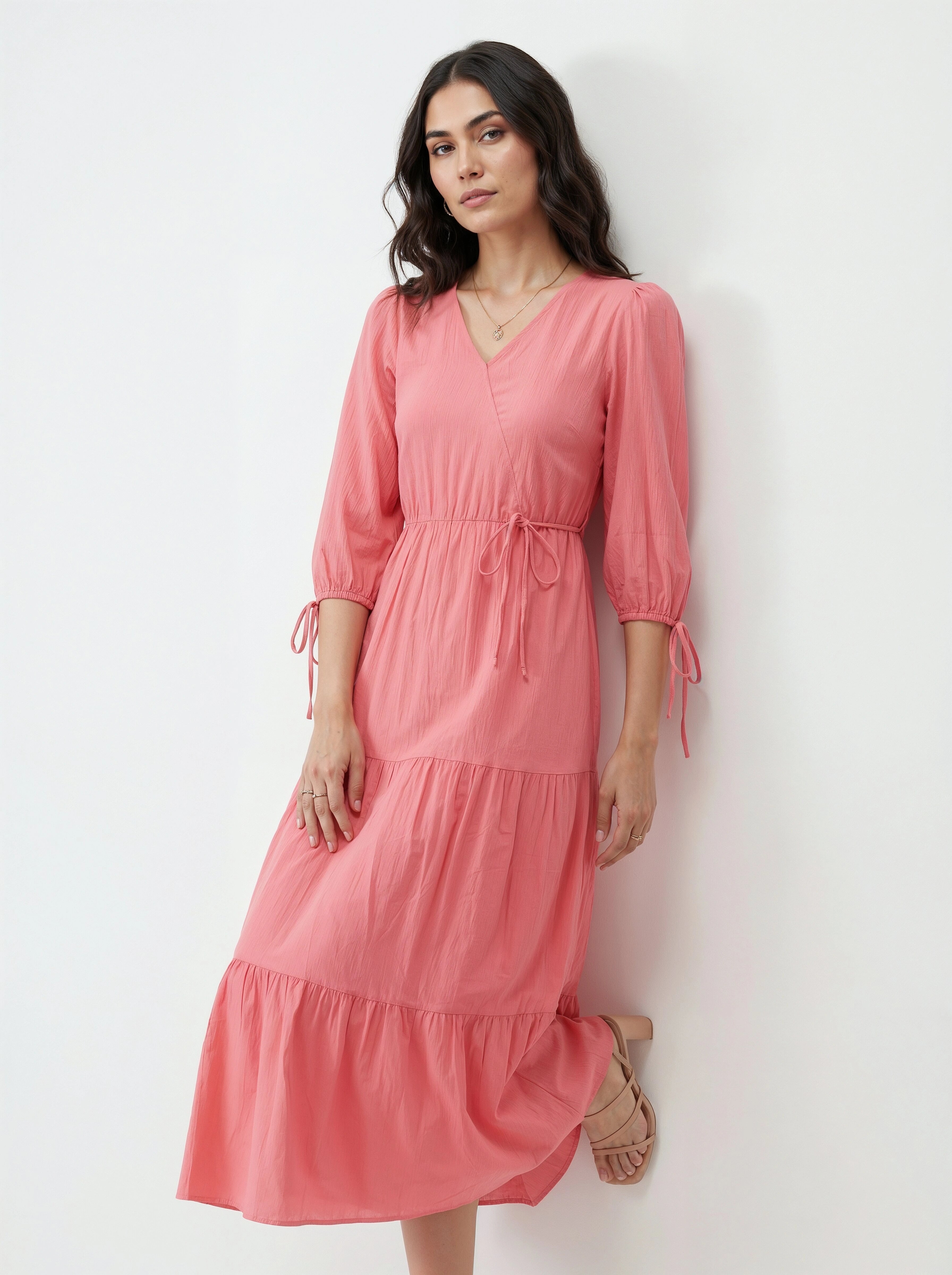 Woman wearing a pink dress against a white background