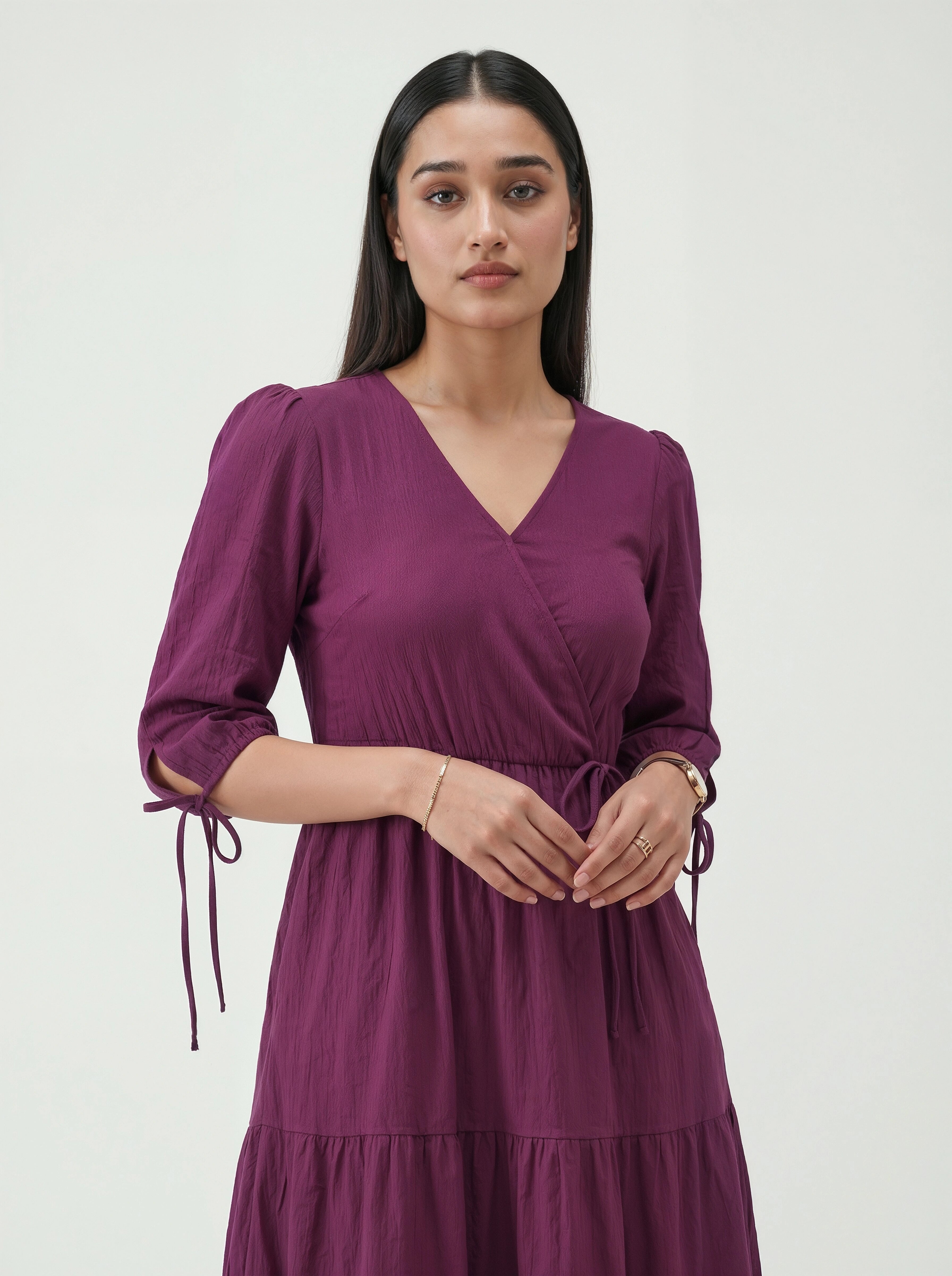 Woman wearing a purple dress against a white background