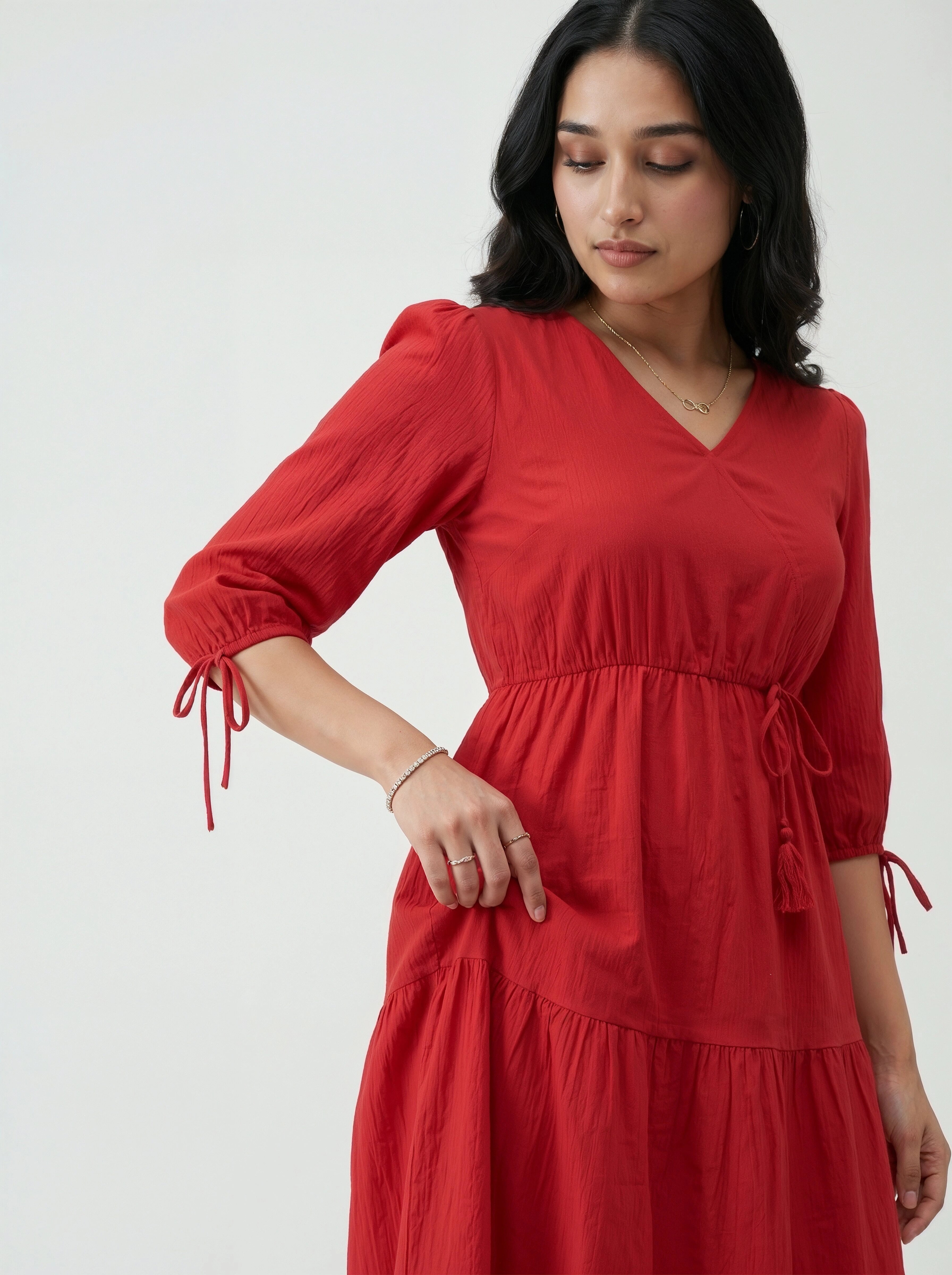 Woman wearing a red dress with a plain background