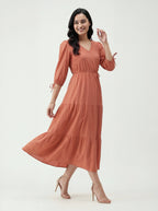 Woman wearing a rust-colored dress on a white background