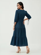 Woman wearing a dark blue dress on a white background
