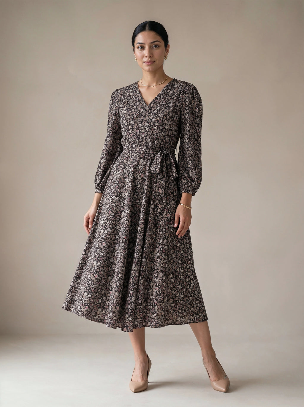 Woman wearing a floral dress against a plain background