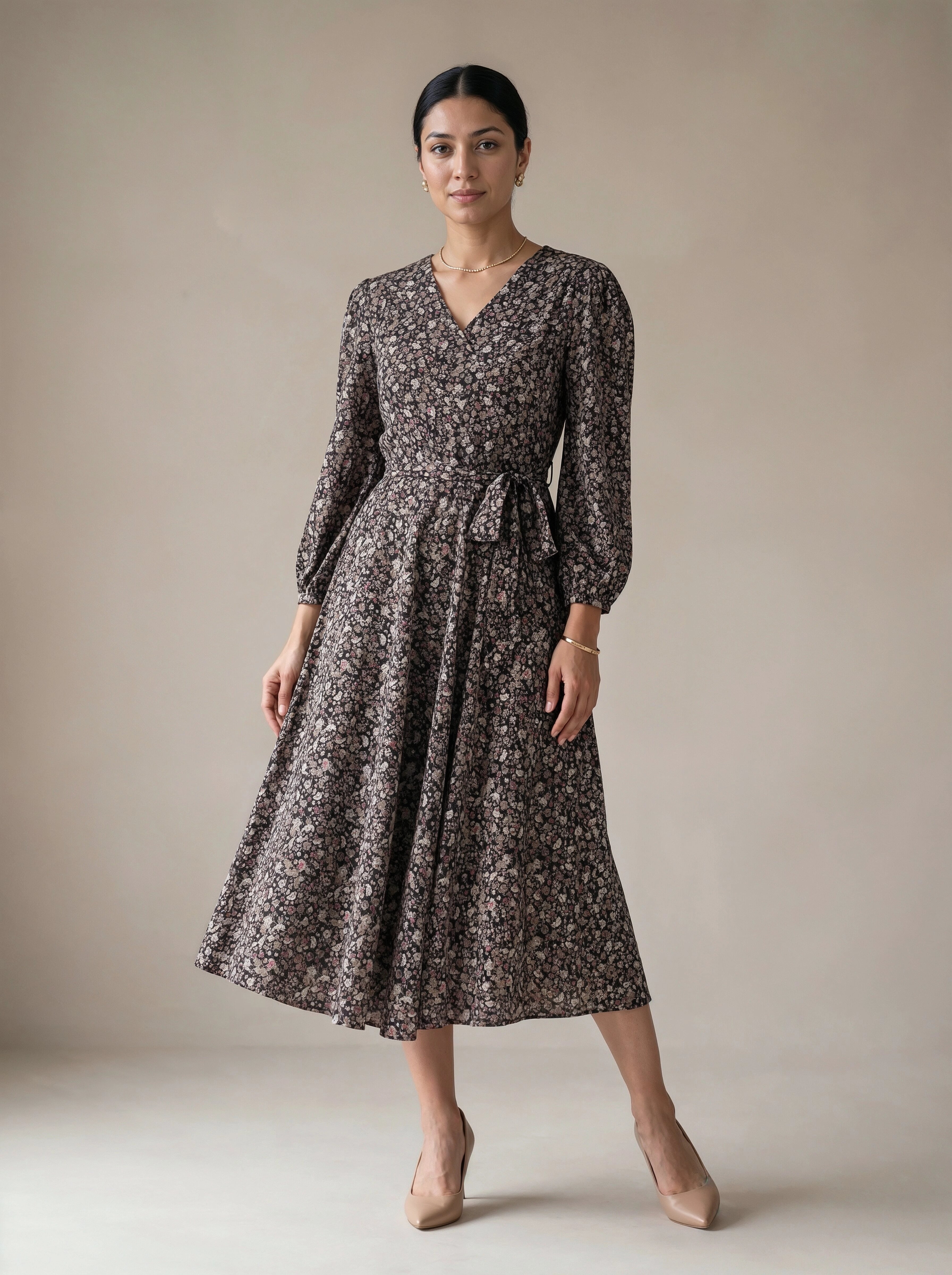 Woman wearing a floral dress against a plain background
