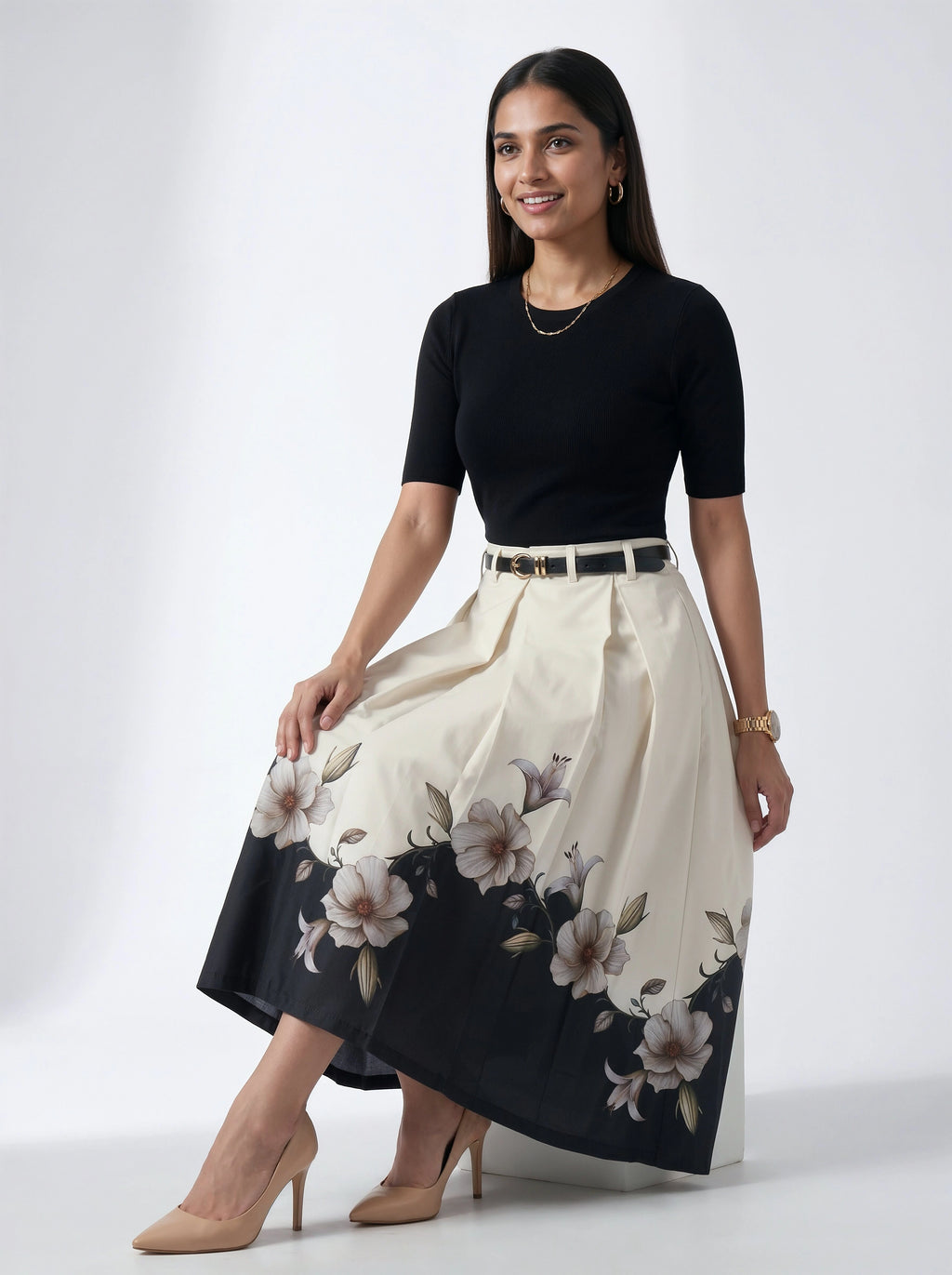 Woman wearing a black top and floral skirt on a white background
