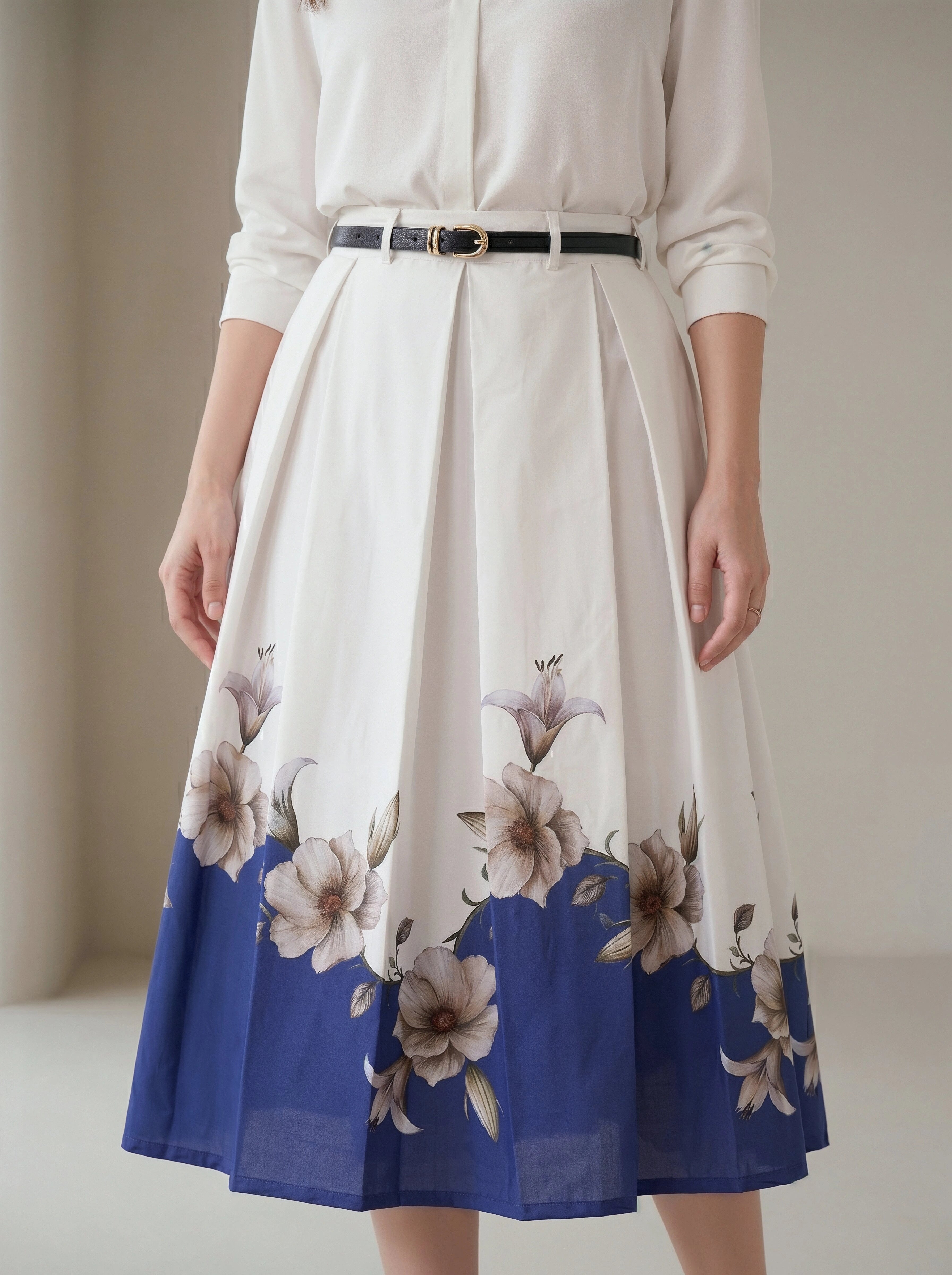 White blouse with a floral skirt featuring blue and beige flowers on a plain background