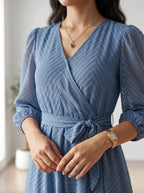 Woman wearing a blue dress with a blurred background