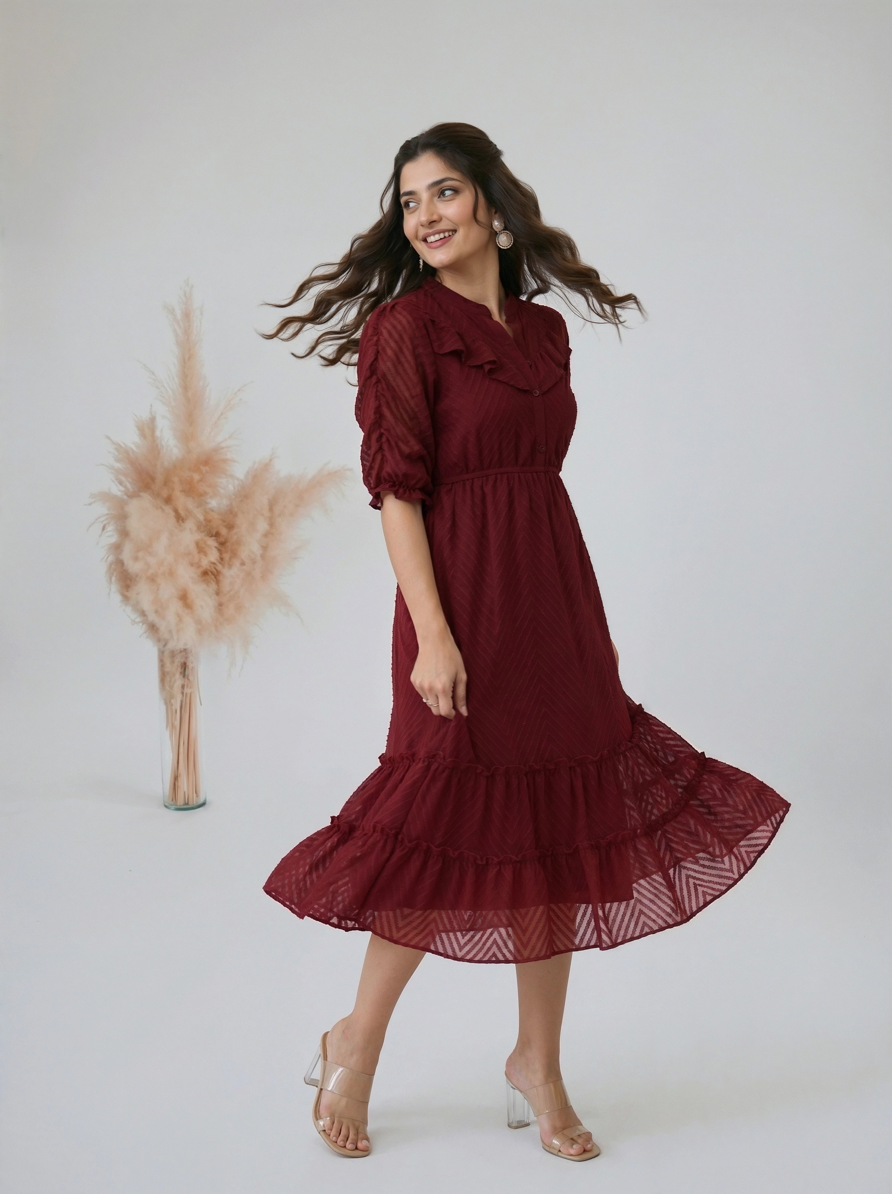 Woman wearing a crimson midi dress with ruffled puff sleeves