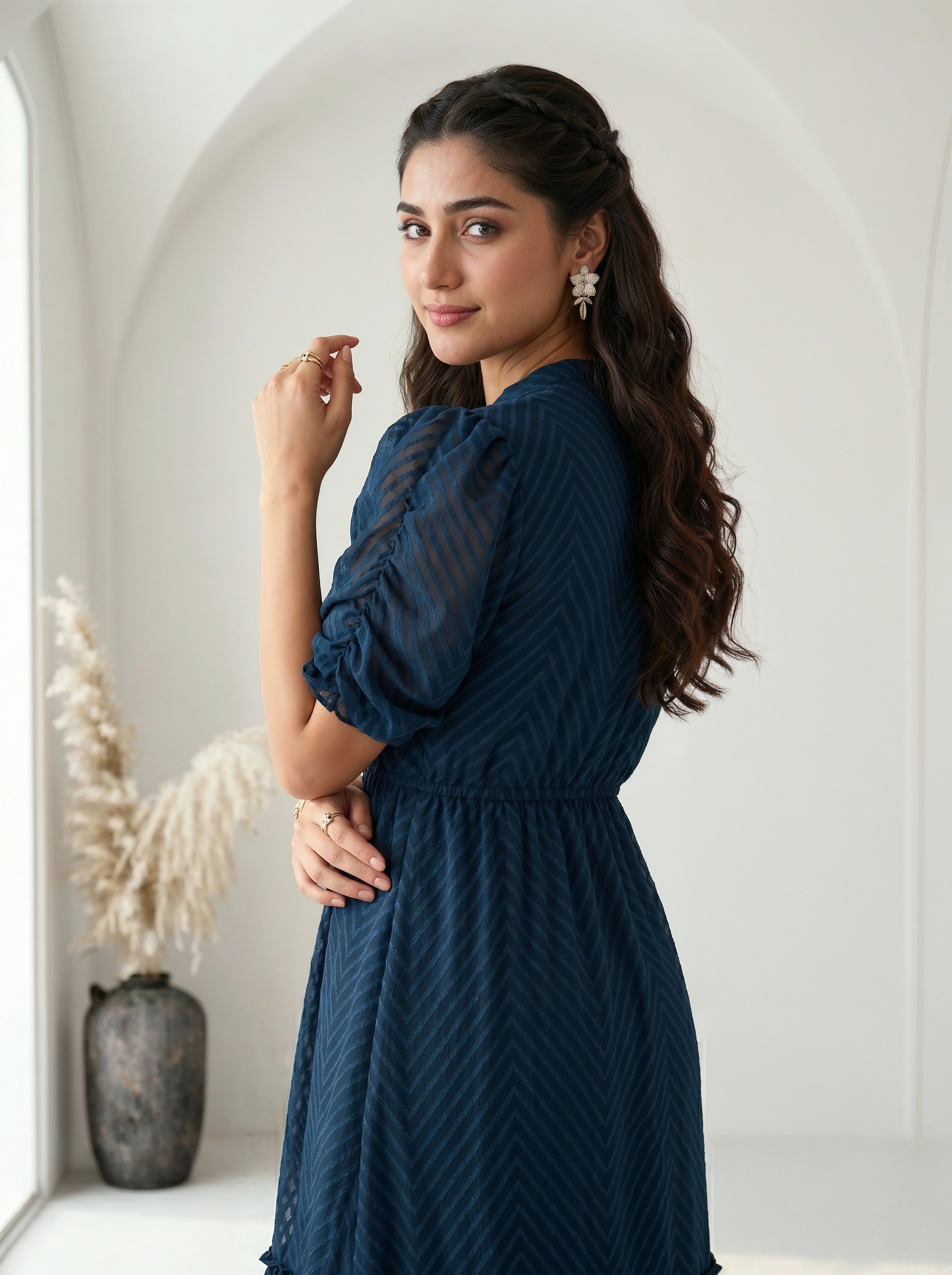 Woman wearing a patterned dress against a plain background