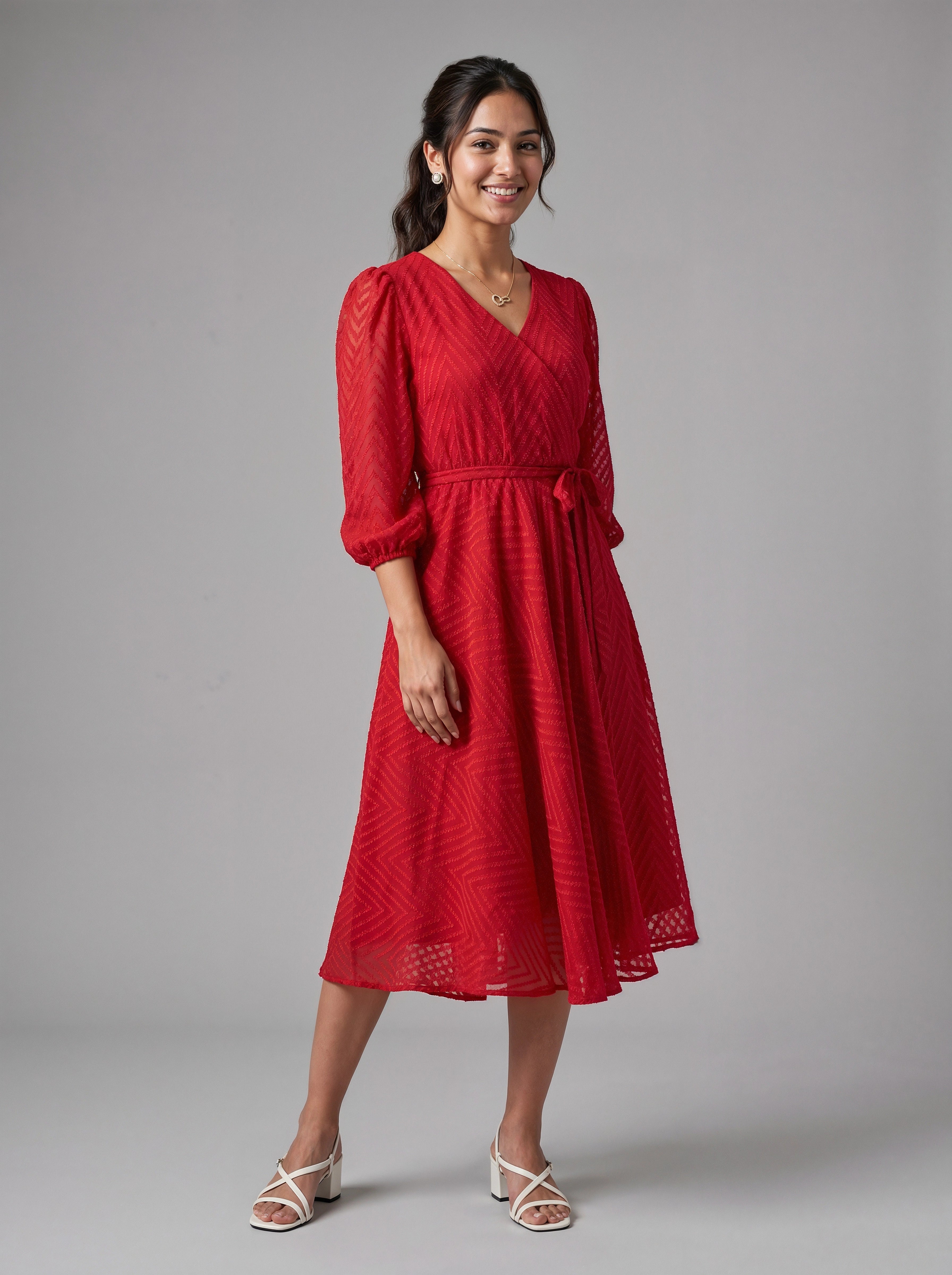 Woman wearing a red dress against a gray background