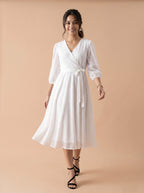 Woman wearing a white dress on a beige background