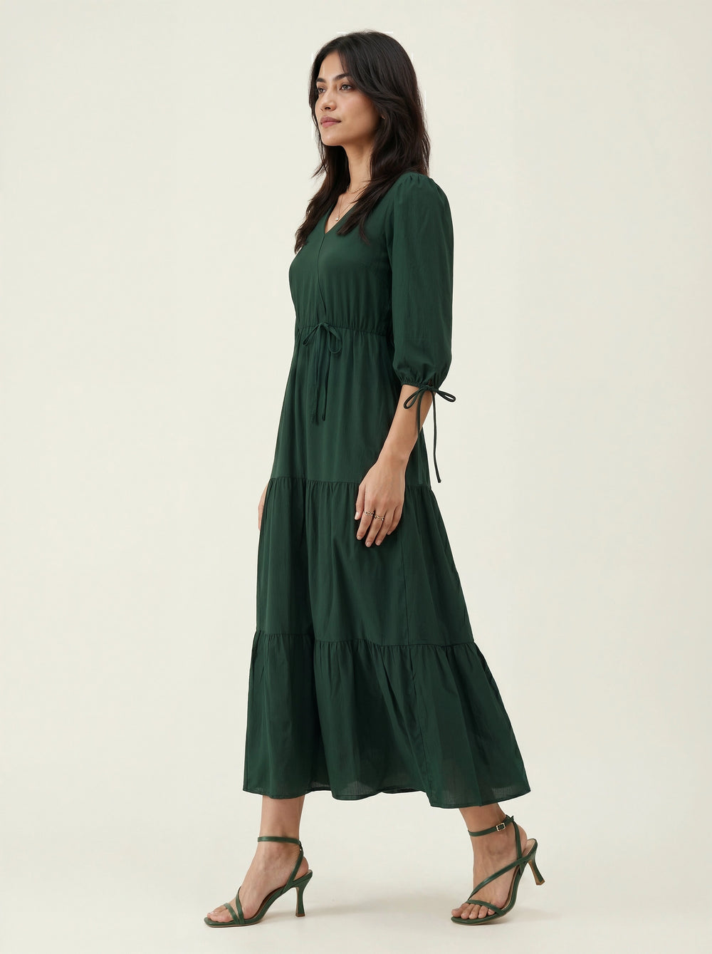 Woman wearing a green dress on a white background