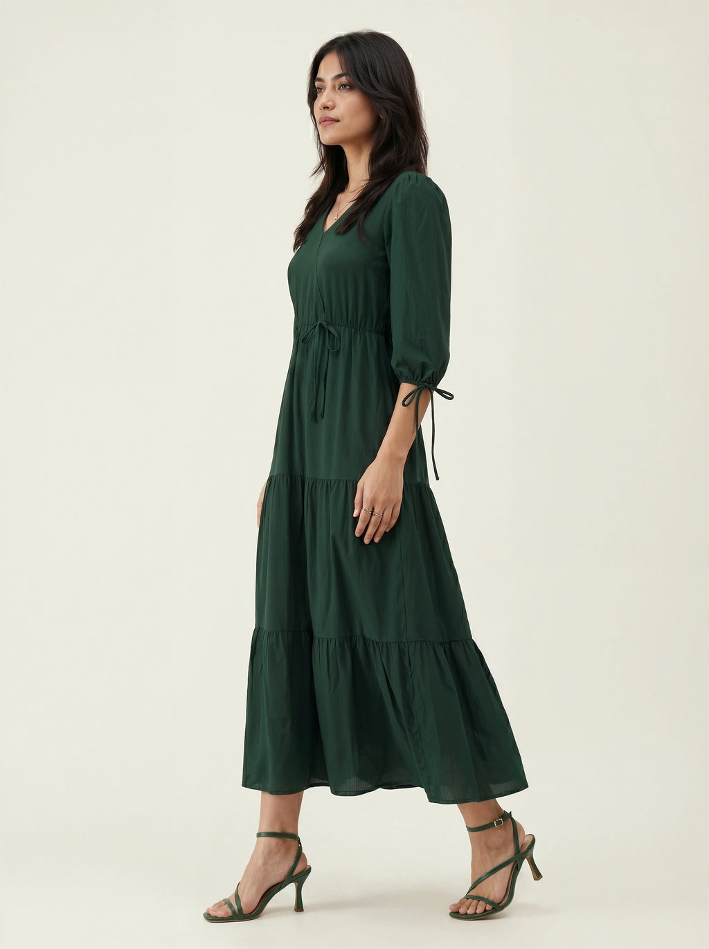 Woman wearing a green dress on a white background