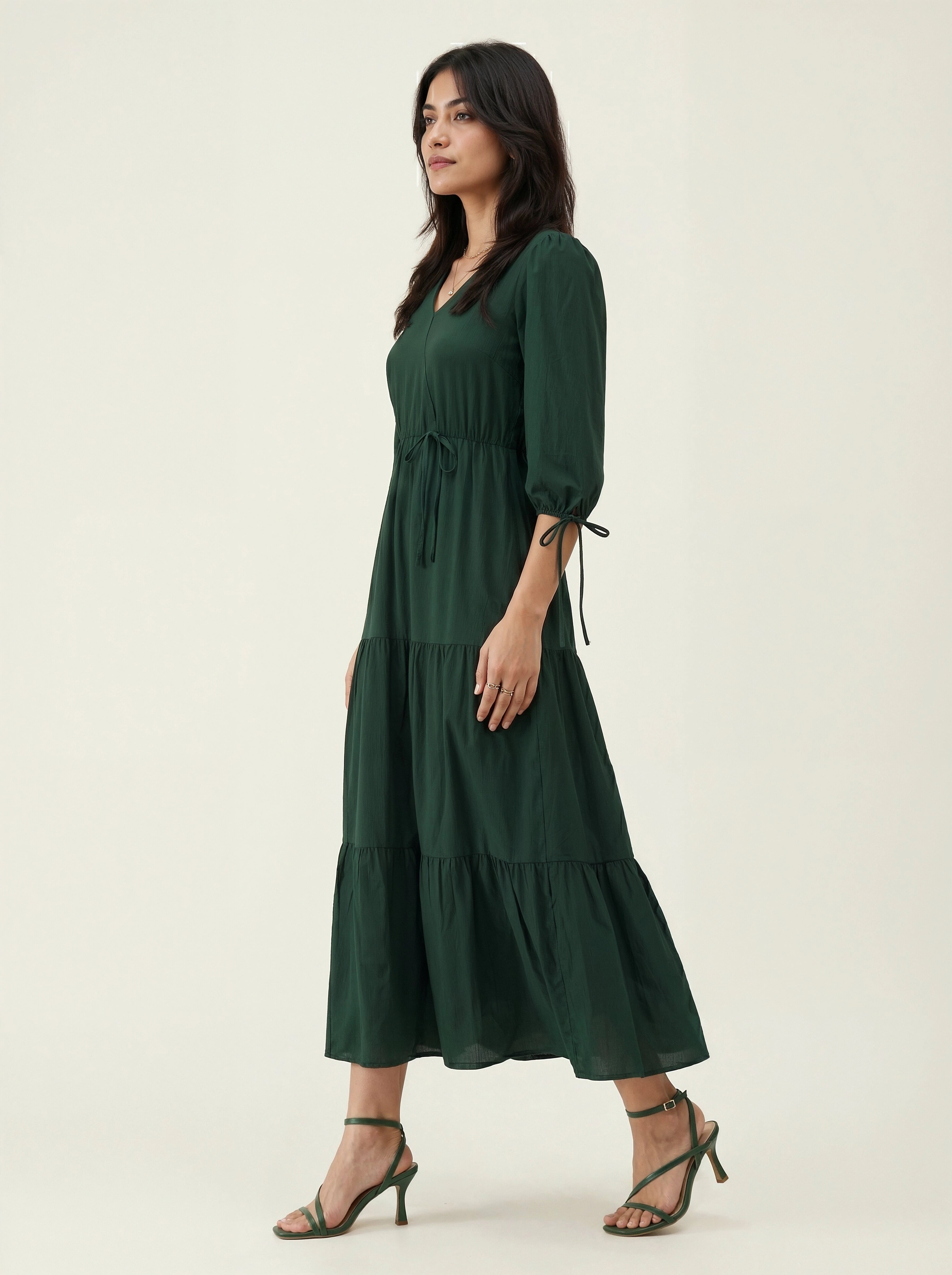 Woman wearing a green dress on a white background