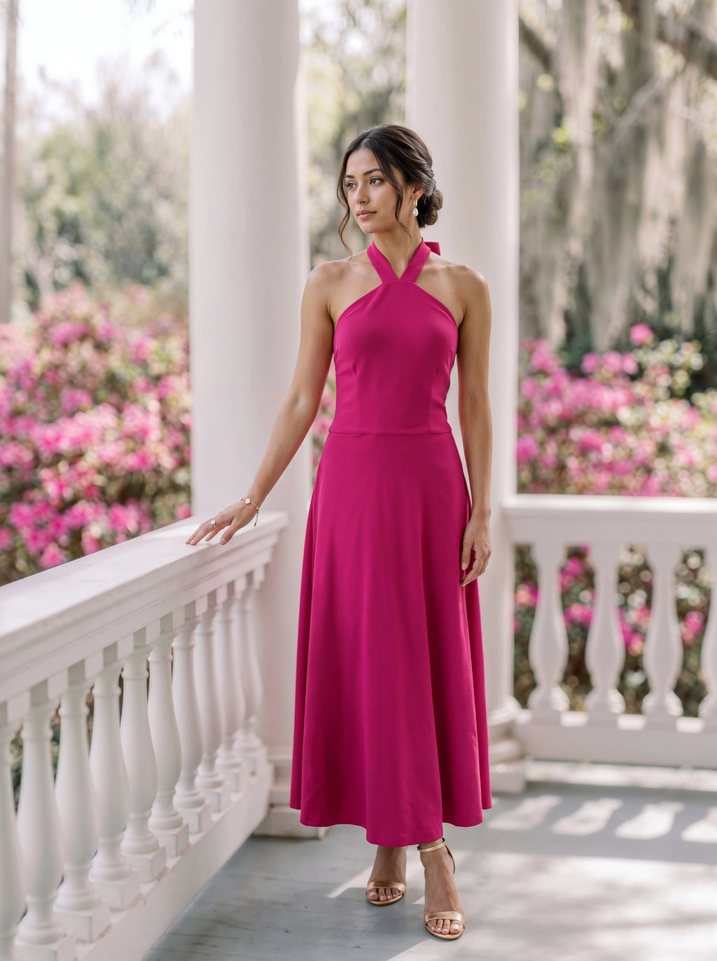 A woman models a terracotta orange tiered mini dress with puff sleeves in a neutral-toned room setting.