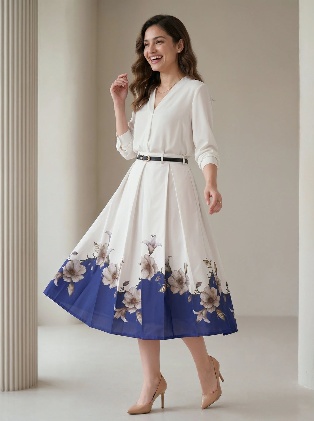 Woman wearing a white dress with floral blue hem in a neutral setting
