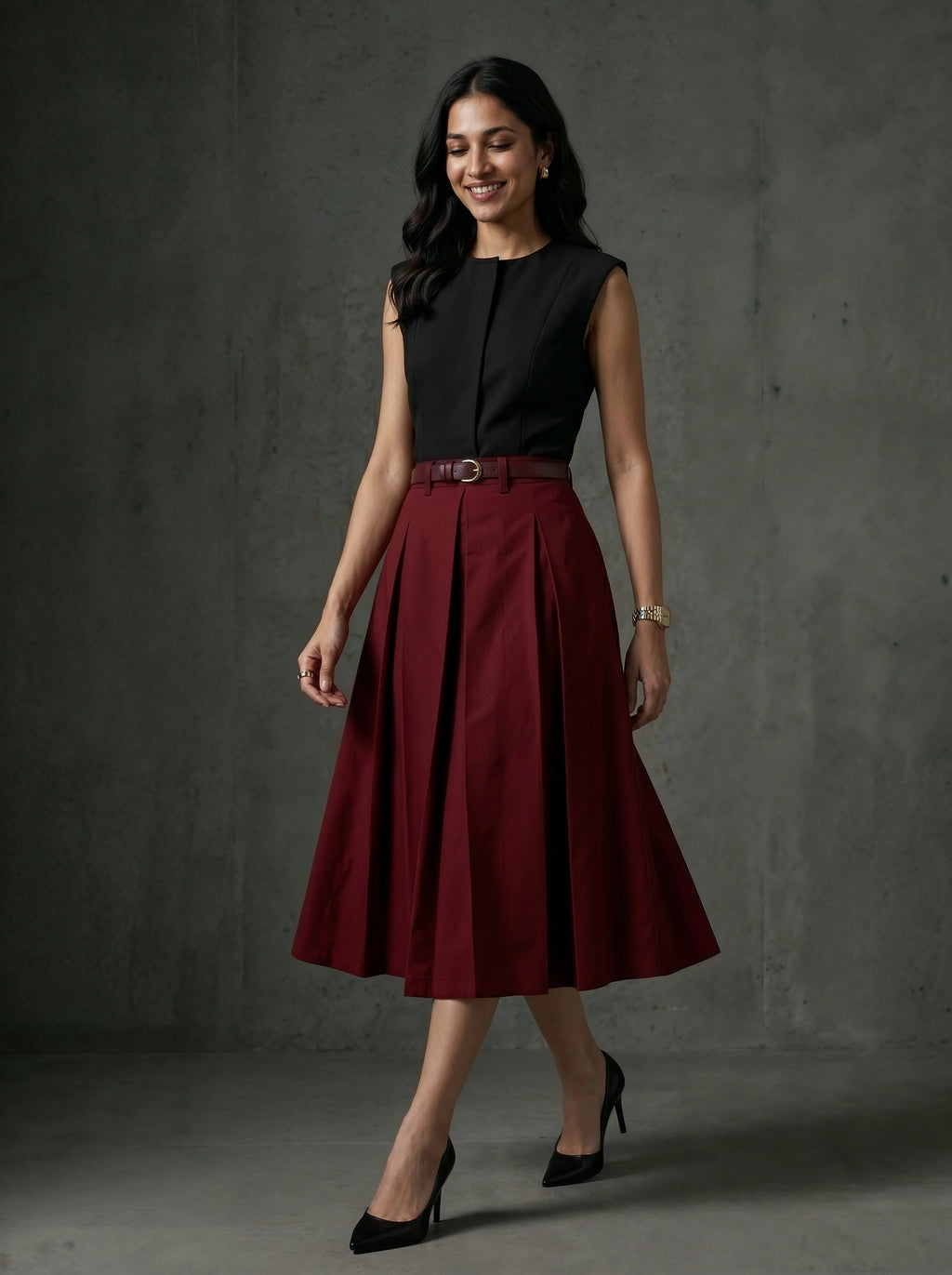 Woman wearing a black sleeveless top and red skirt against a gray background