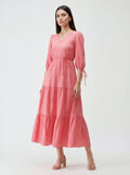 Woman wearing a pink dress on a white background