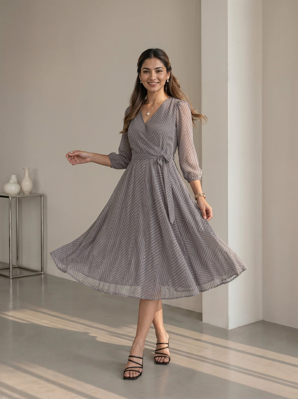 Woman wearing a gray patterned dress in an indoor setting