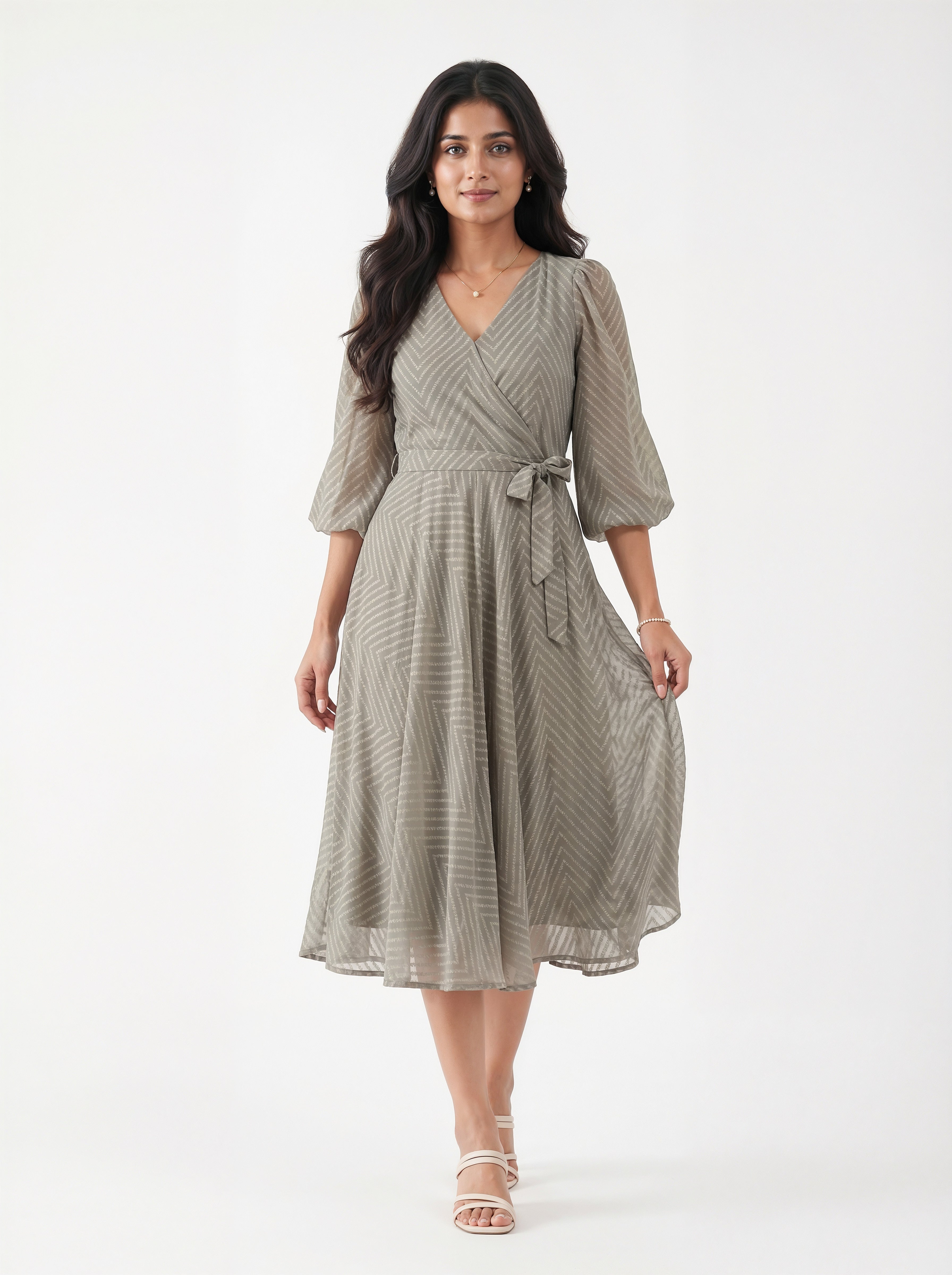 Woman wearing a gray dress with a white background