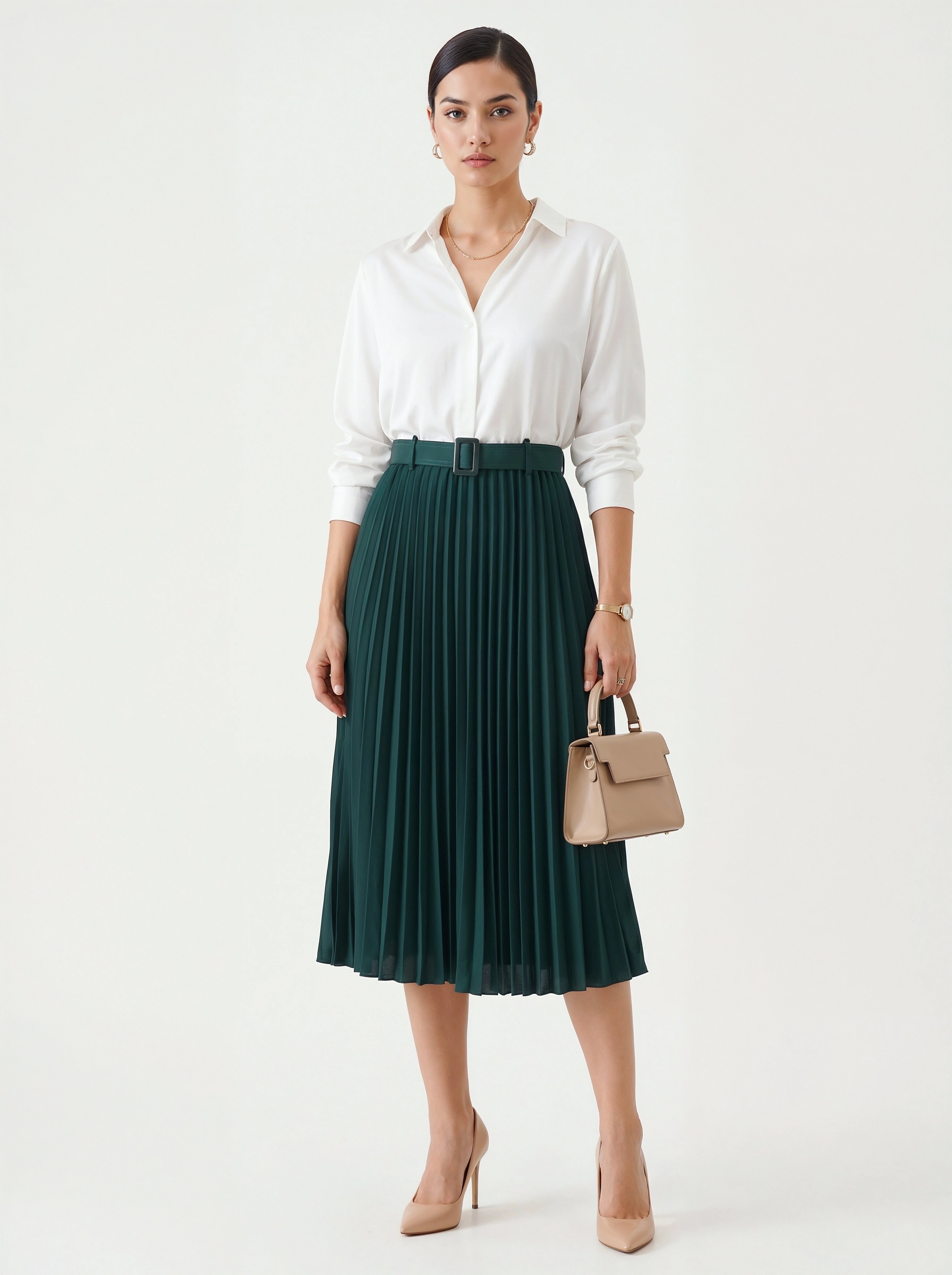 Woman wearing a white blouse and green pleated skirt holding a beige handbag on a white background