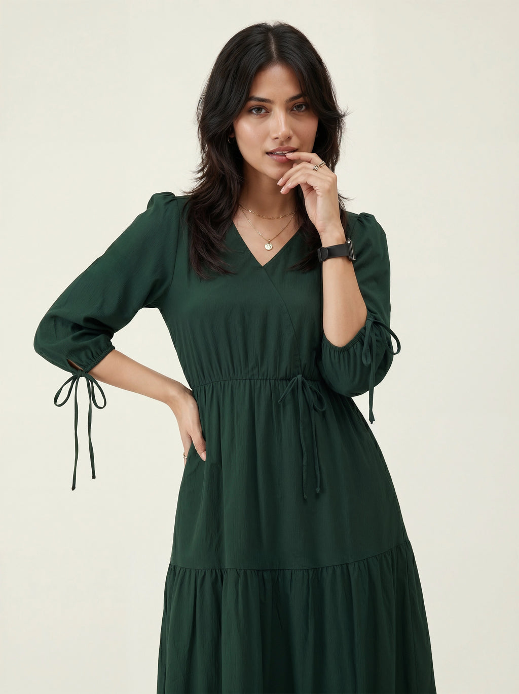 Woman wearing a green dress on a plain background