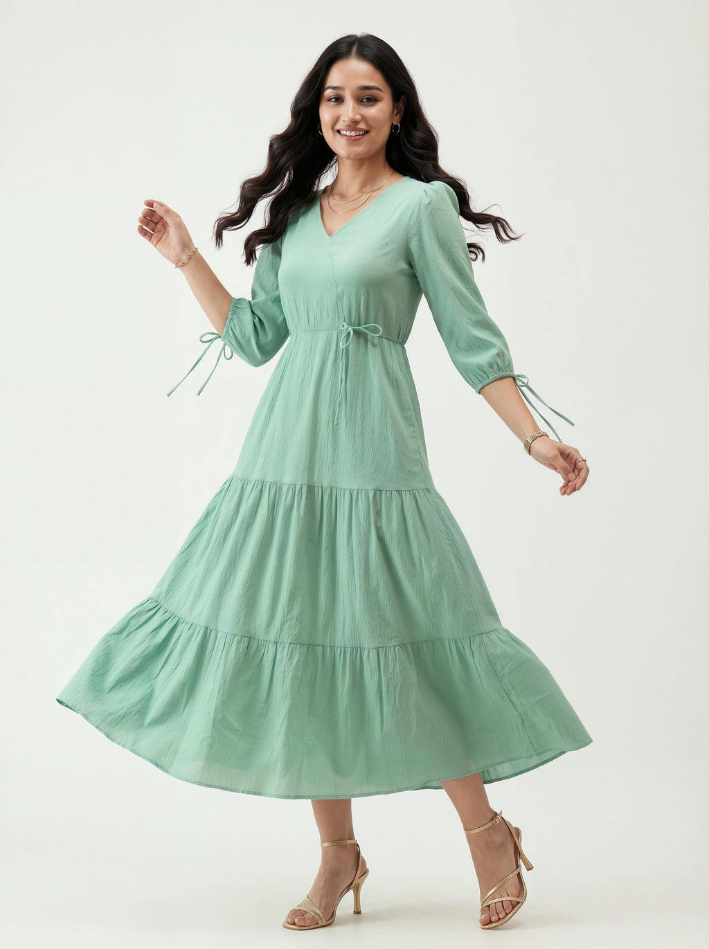 Woman wearing a light green dress on a white background