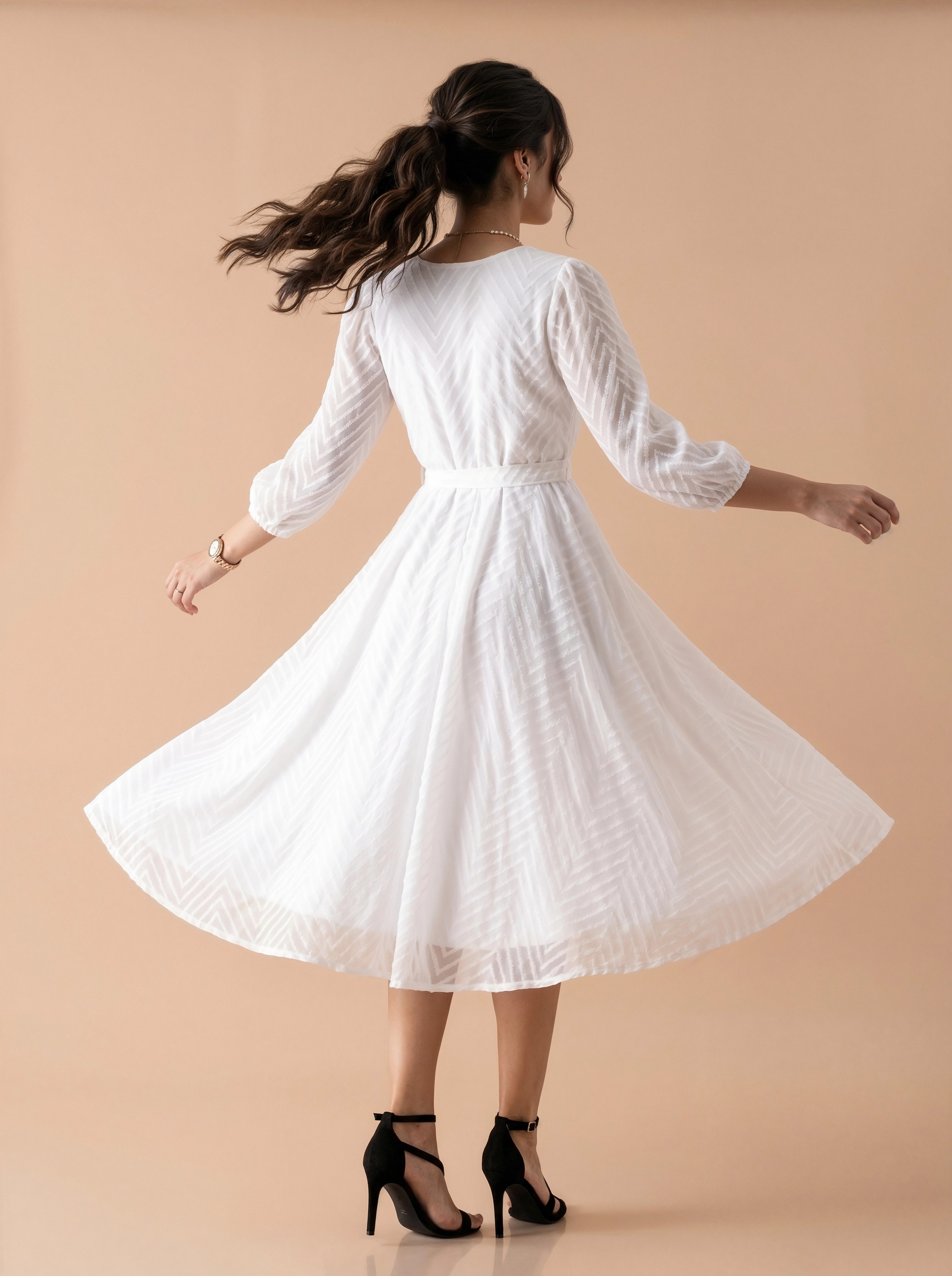 Woman wearing a white dress against a beige background