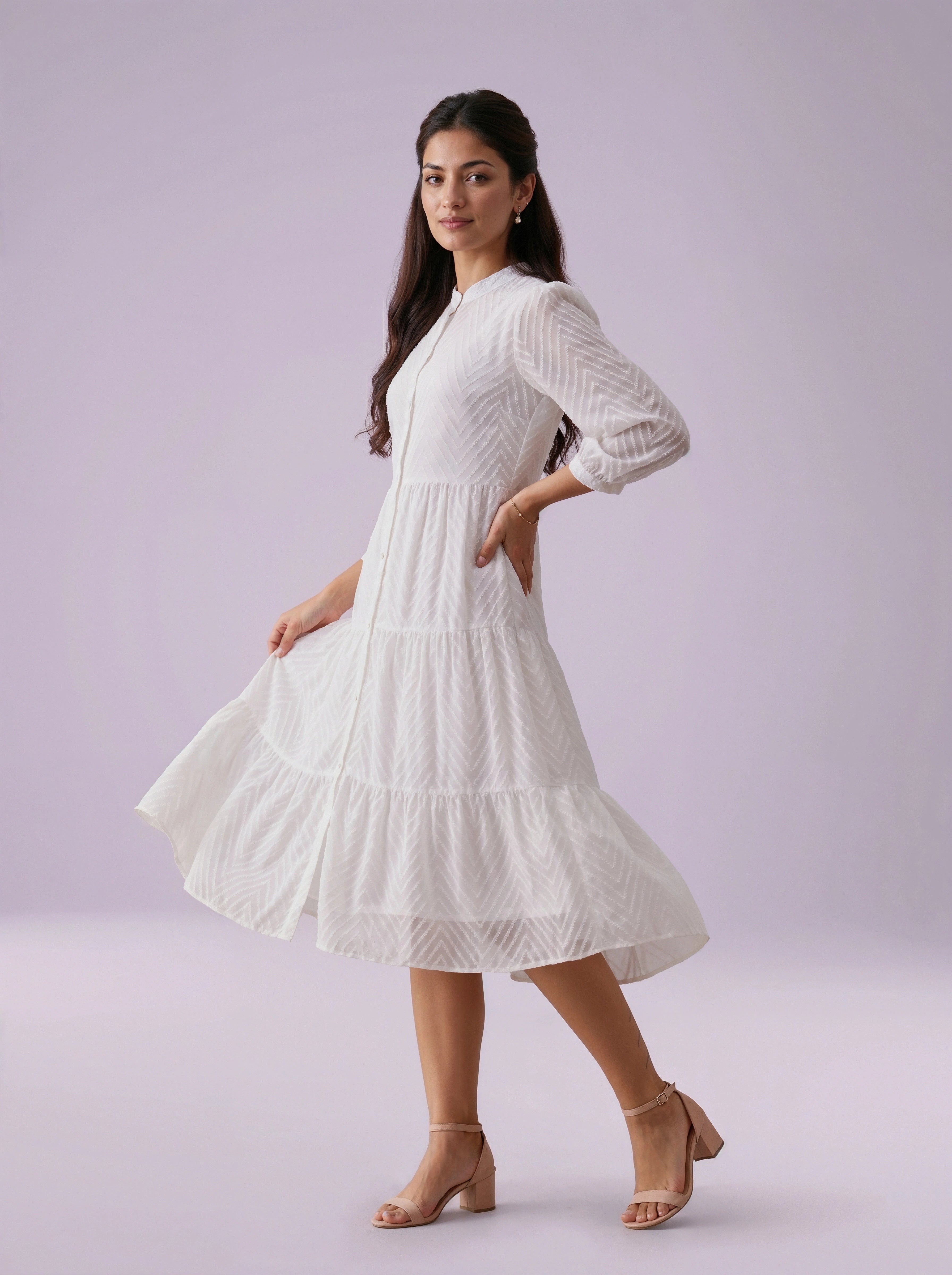 Woman wearing a white dress against a light purple background