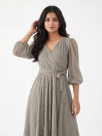 Woman wearing a patterned dress on a white background