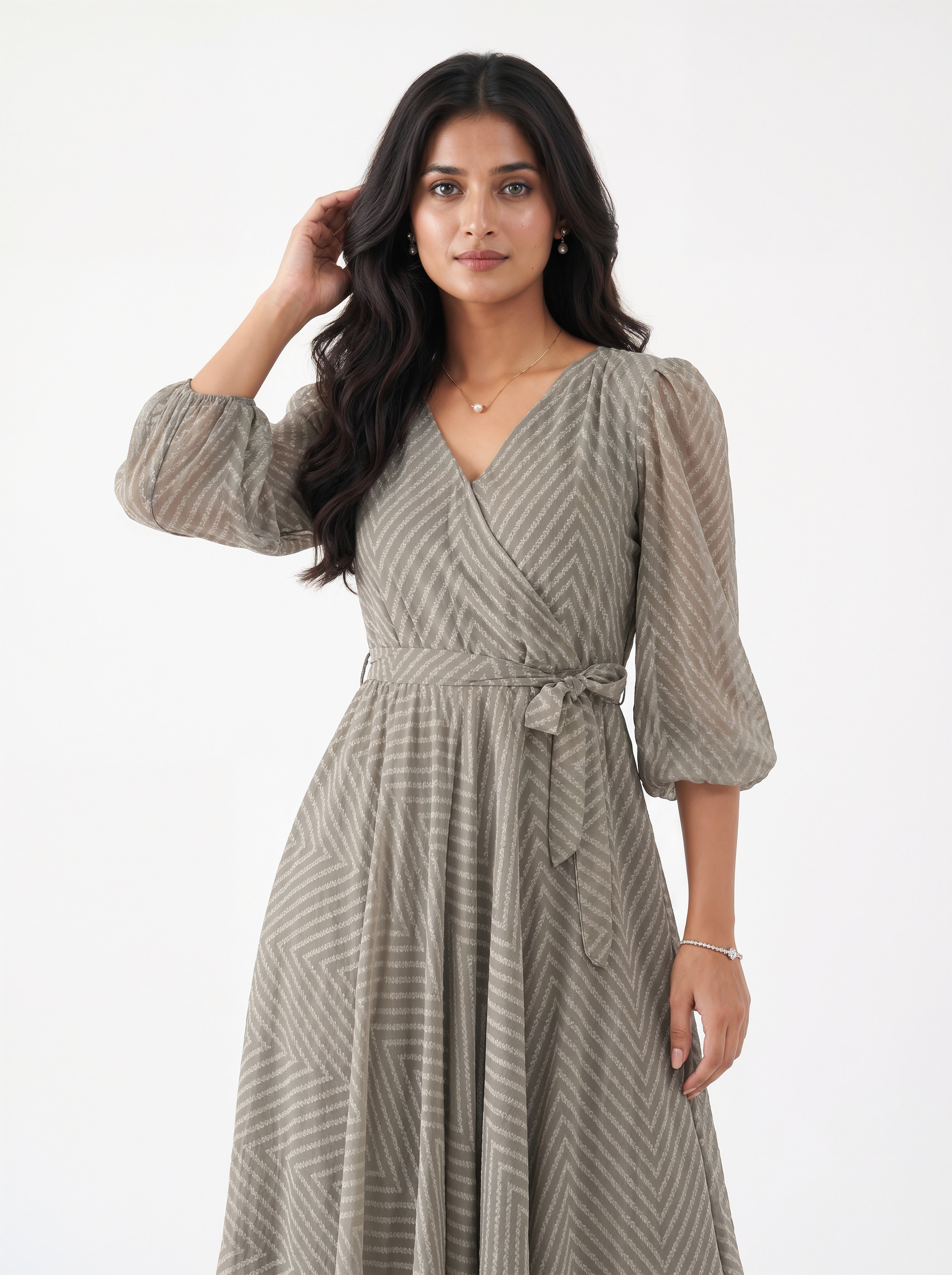 Woman wearing a patterned dress on a white background