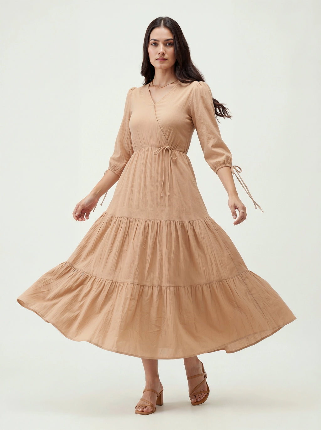 Woman wearing a beige dress on a white background